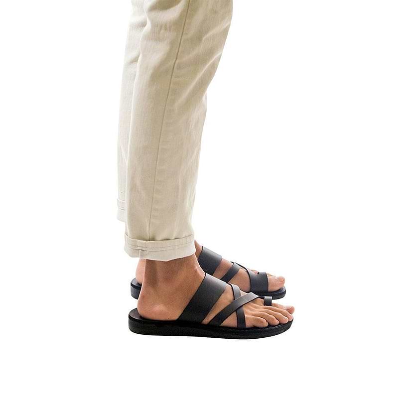 Model wearing The Good Shepherd black, handmade leather slide sandals with toe loop