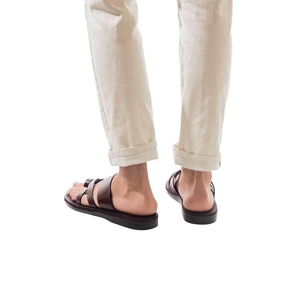 Model wearing The Good Shepherd brown, handmade leather slide sandals with toe loop