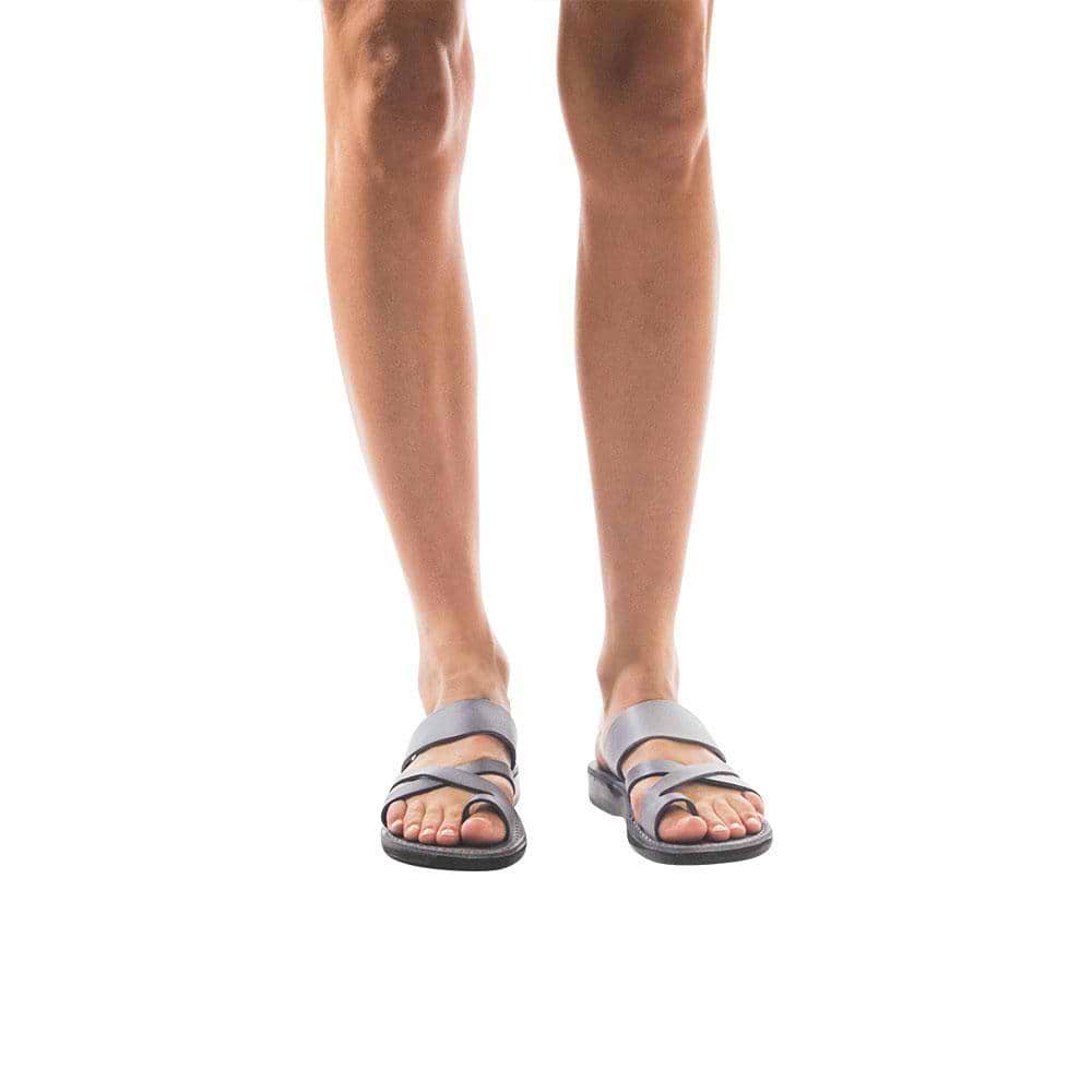 Model wearing The Good Shepherd gray, handmade leather slide sandals with toe loop