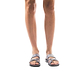 Model wearing The Good Shepherd gray, handmade leather slide sandals with toe loop