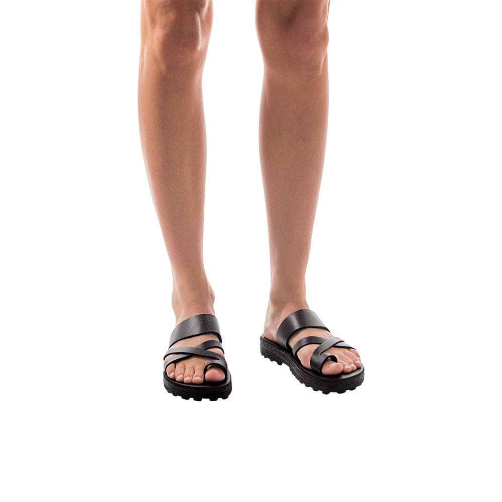 Model wearing The Good Shepherd Molded black, handmade leather slide sandals with toe loop