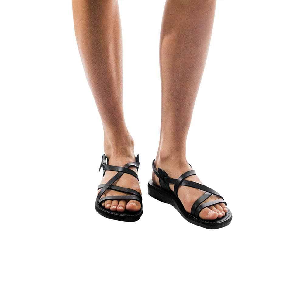 Model wearing Tzippora black, handmade leather sandals with back strap