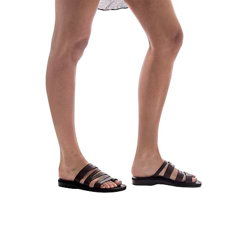 Model wearing Zoey brown, handmade leather slide sandals with toe loop 