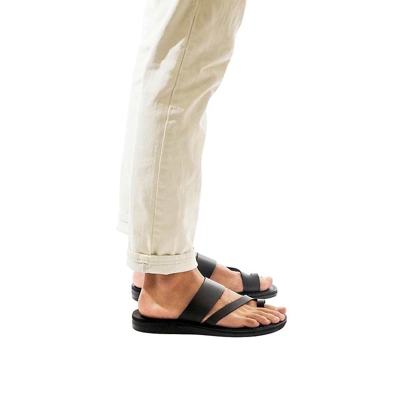 Model wearing Zohar black, handmade leather slide sandals with toe loop