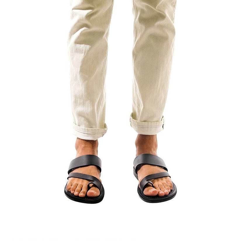 Model wearing Zohar black, handmade leather slide sandals with toe loop