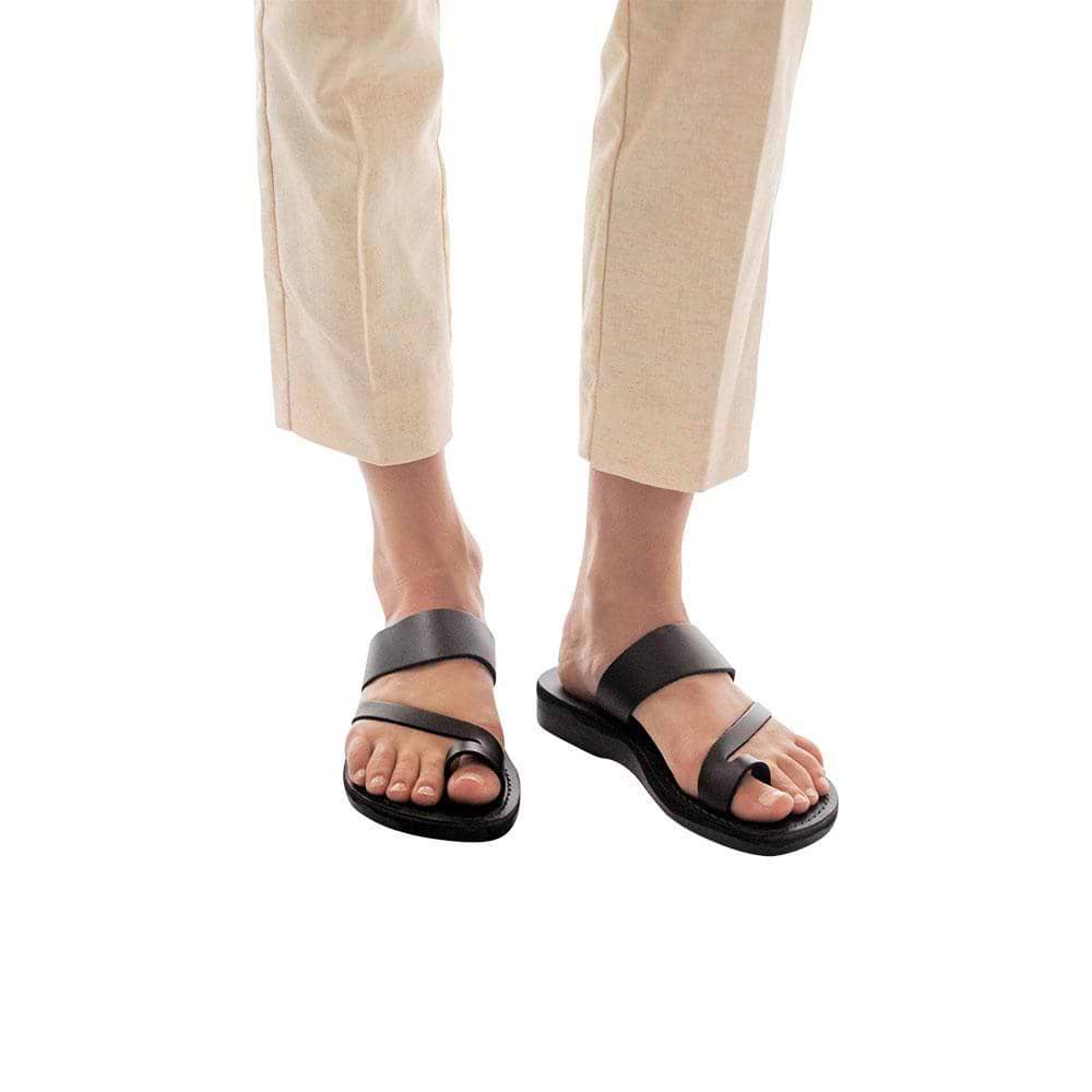 Model wearing Zohar black, handmade leather slide sandals with toe loop