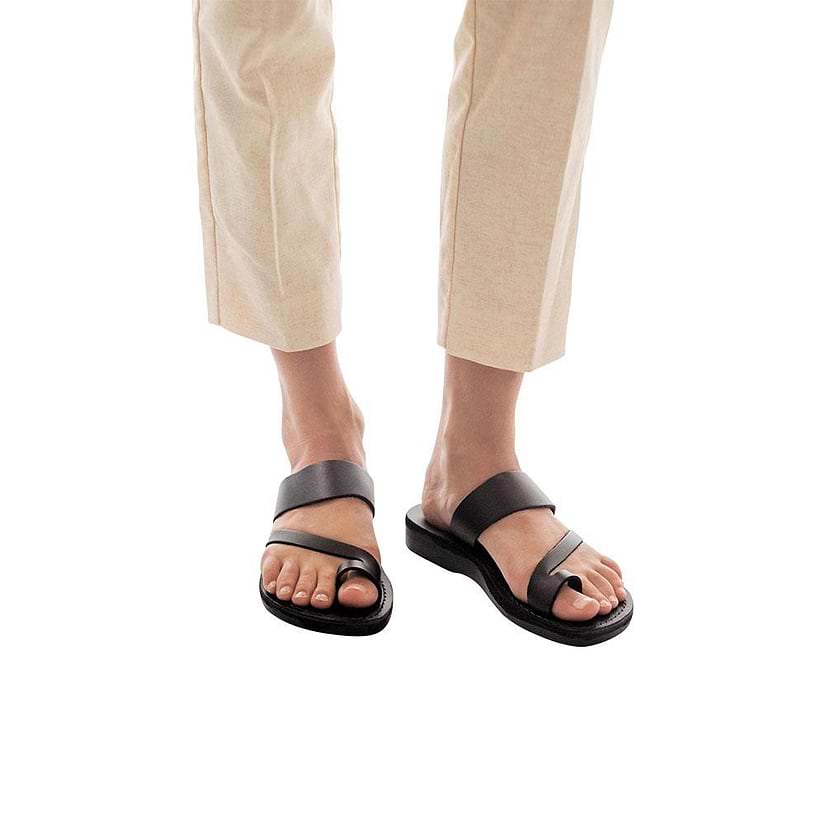 Model wearing Zohar black, handmade leather slide sandals with toe loop