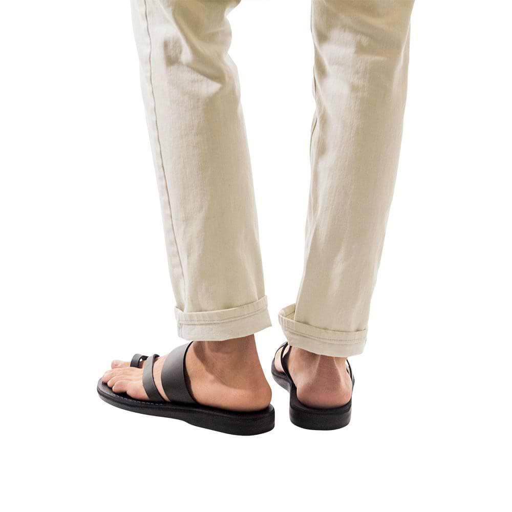 Model wearing Zohar black, handmade leather slide sandals with toe loop