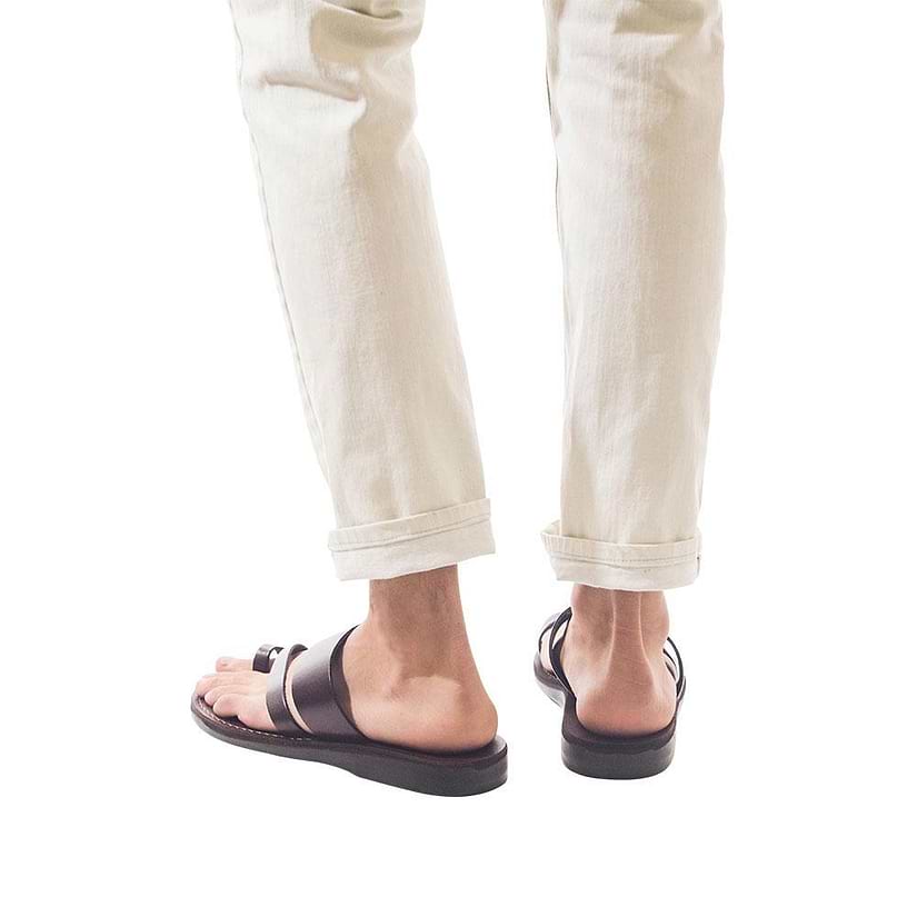 Model wearing Zohar brown, handmade leather slide sandals with toe loop