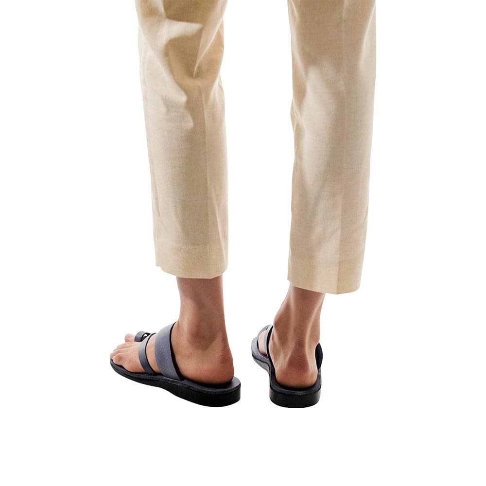 Model wearing Zohar gray, handmade leather slide sandals with toe loop