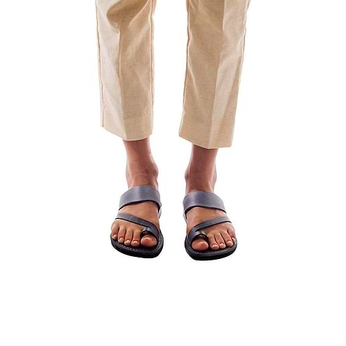 Model wearing Zohar gray, handmade leather slide sandals with toe loop