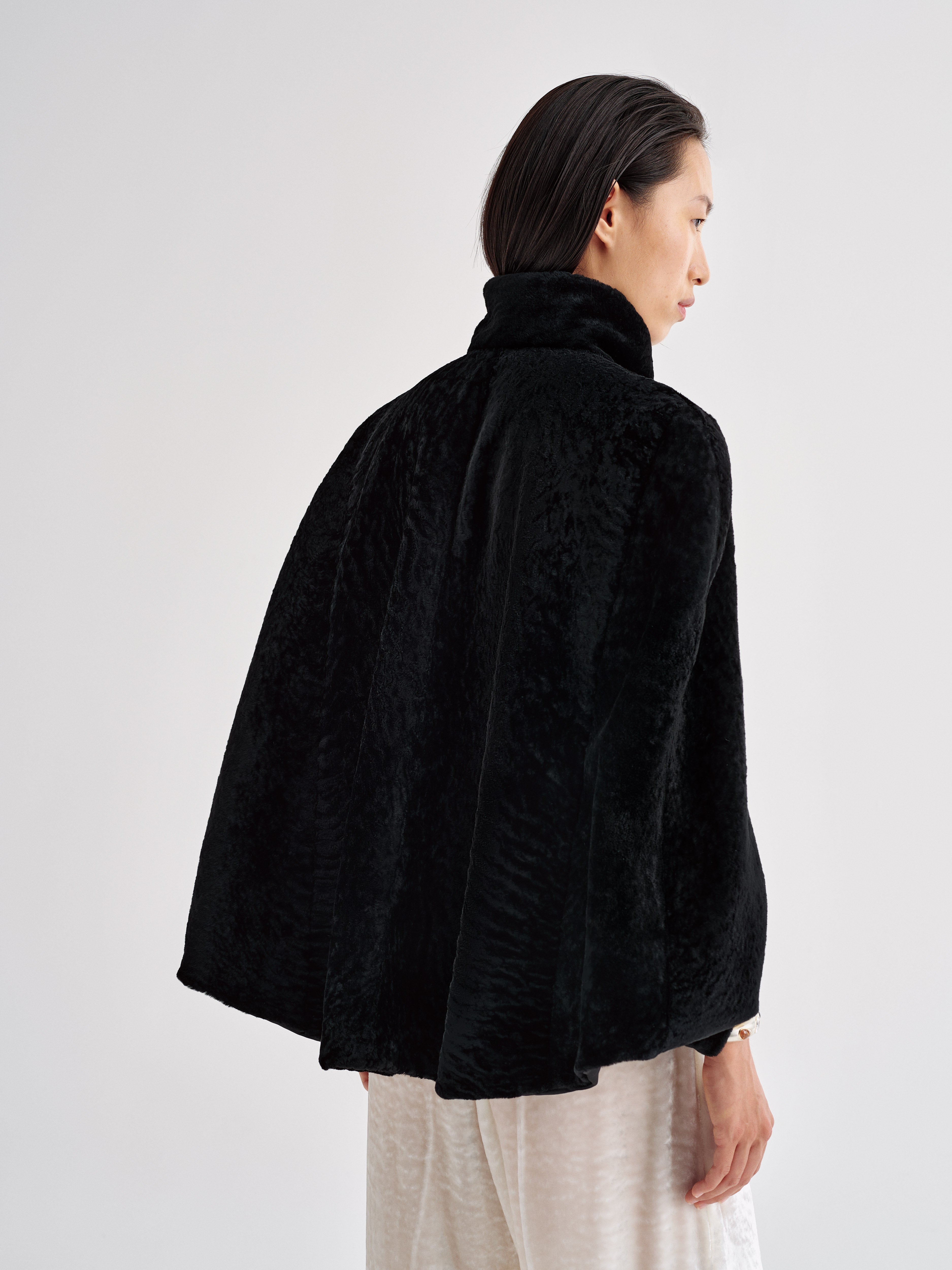 AFLALO Cena Cape in Shearling, Black, back view on model