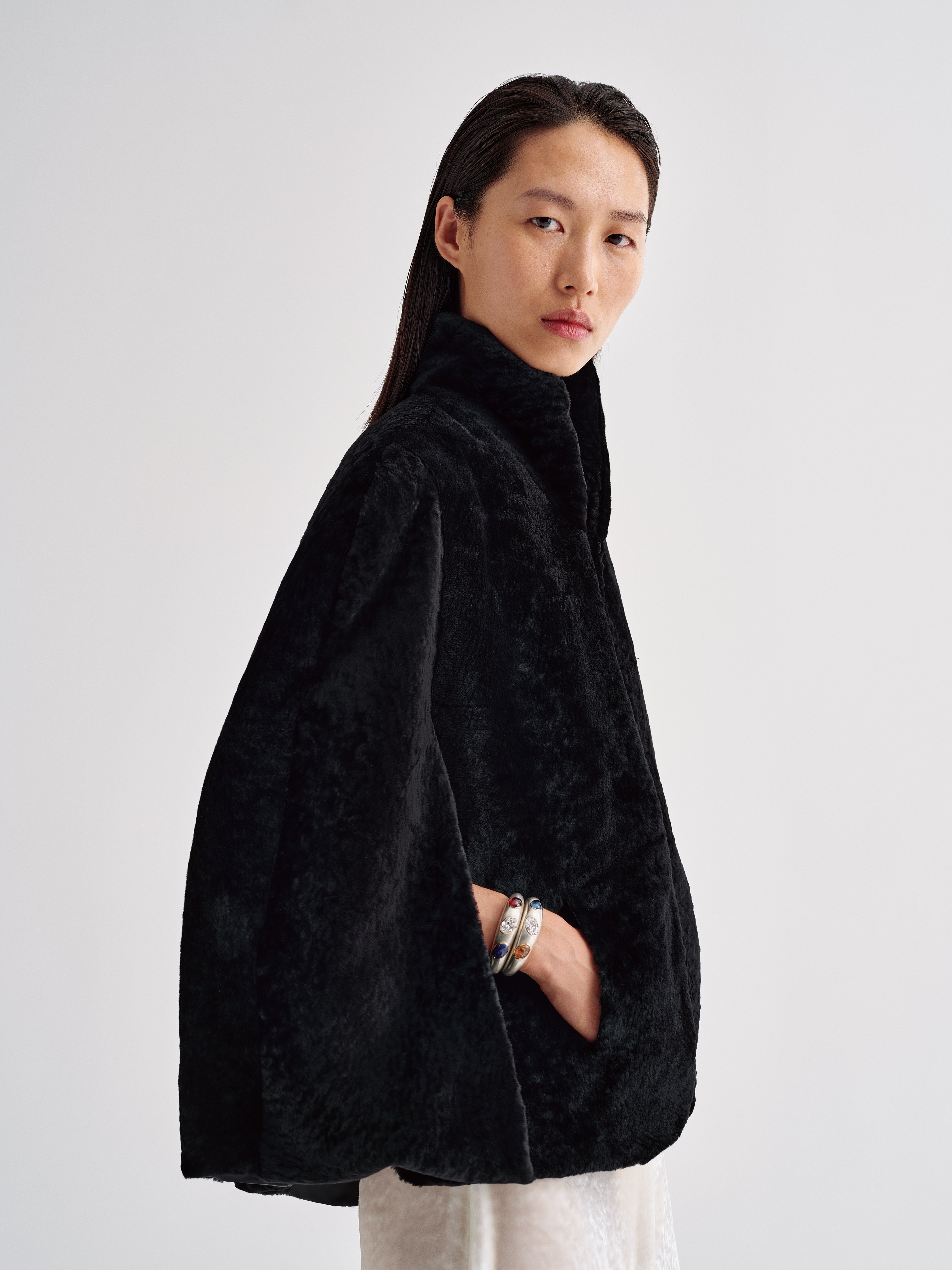 AFLALO Cena Cape in Shearling, Black, side view on model