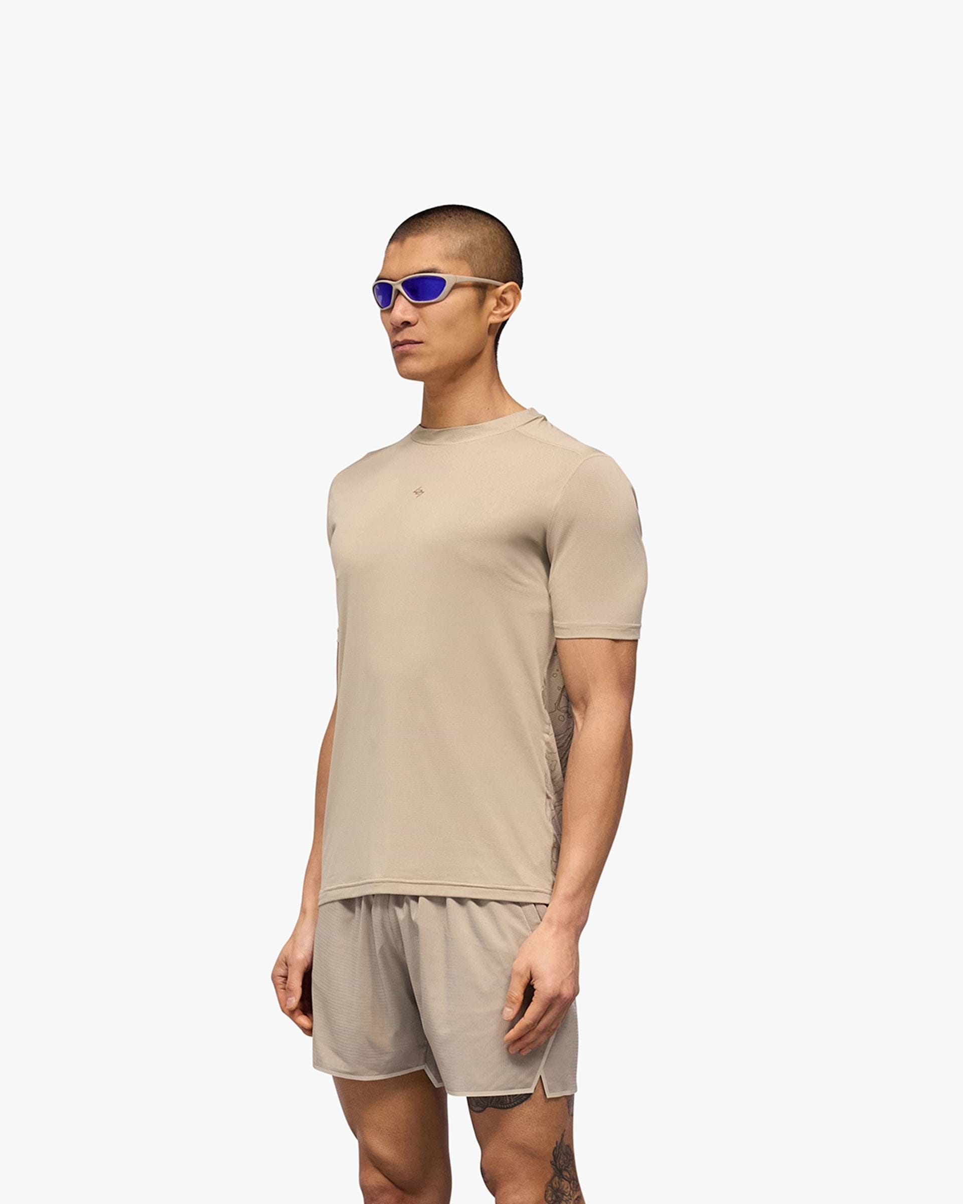 Man wearing a grey technical t-shirt on a plain white background | 247 Contour Run T-Shirt in Pebble | Breathable running t-shirt with contour print | 247 T-Shirts | Represent Clo