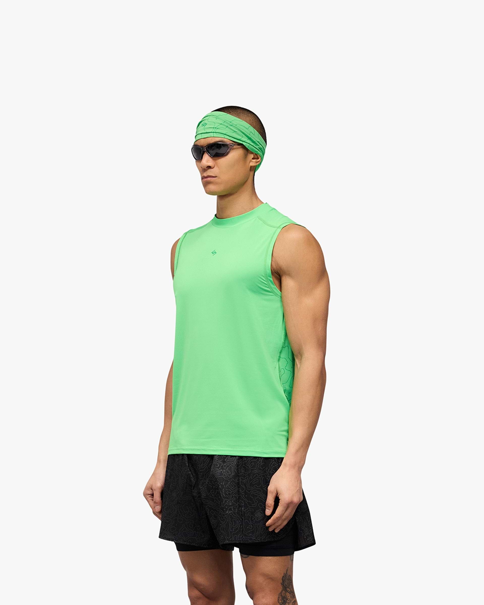Man wearing a green running tank on a plain white background | 247 Contour Run Tank in Speed Green | Breathable mesh running tank | 247 T-Shirts | Represent Clo
