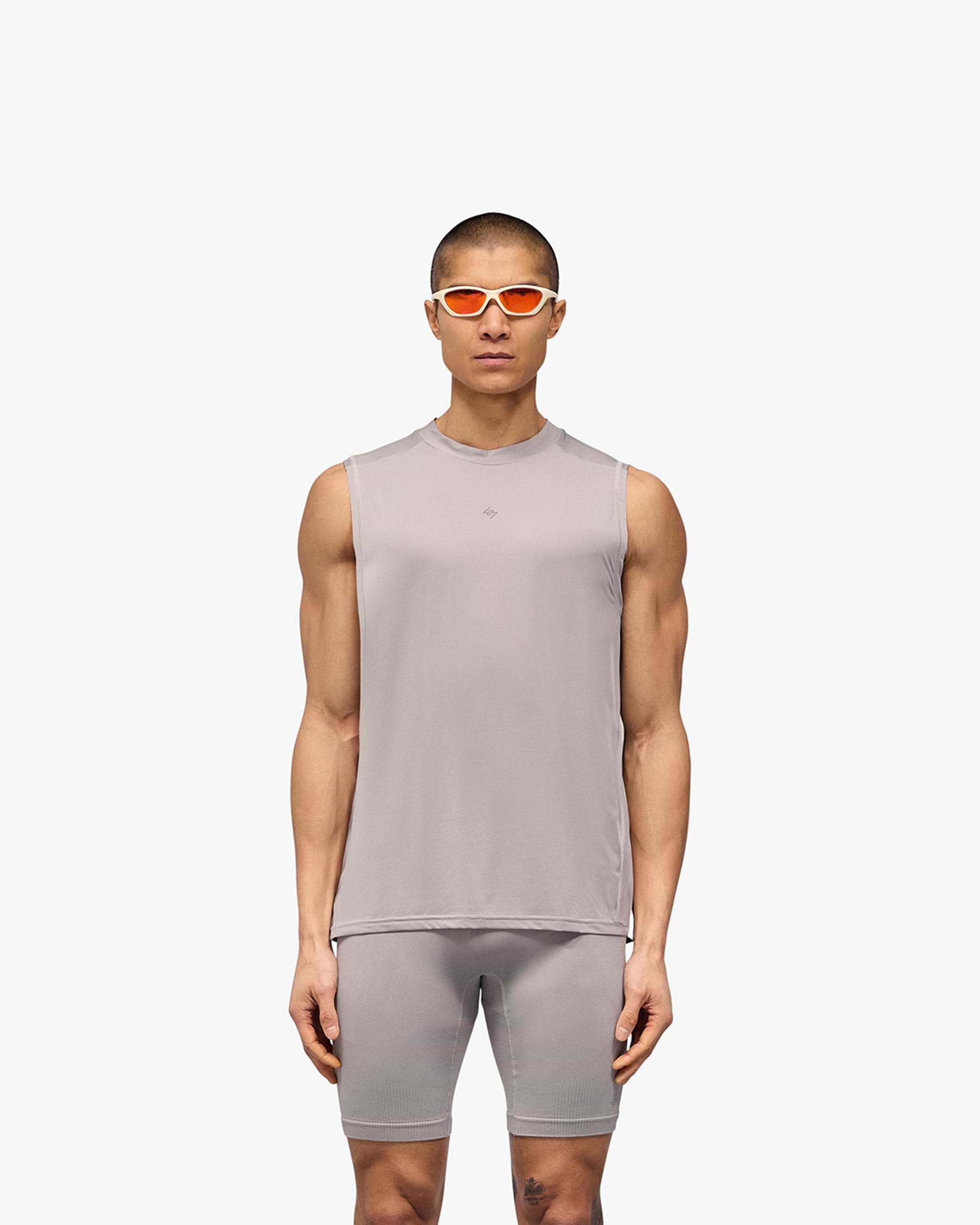 Man wearing a grey technical tank top on a plain white background | 247 Contour Run Tank in Titanium | Breathable and sweat-wicking running tank | 247 T-Shirts | Represent Clo
