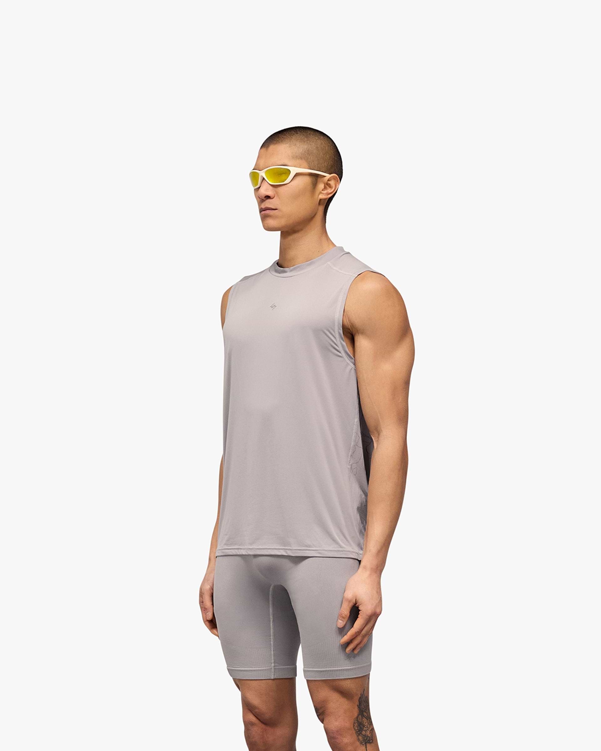 Man wearing a grey running tank on a plain white background | 247 Contour Run Tank in Titanium | Breathable sweat-wicking running tank | 247 T-Shirts | Represent Clo