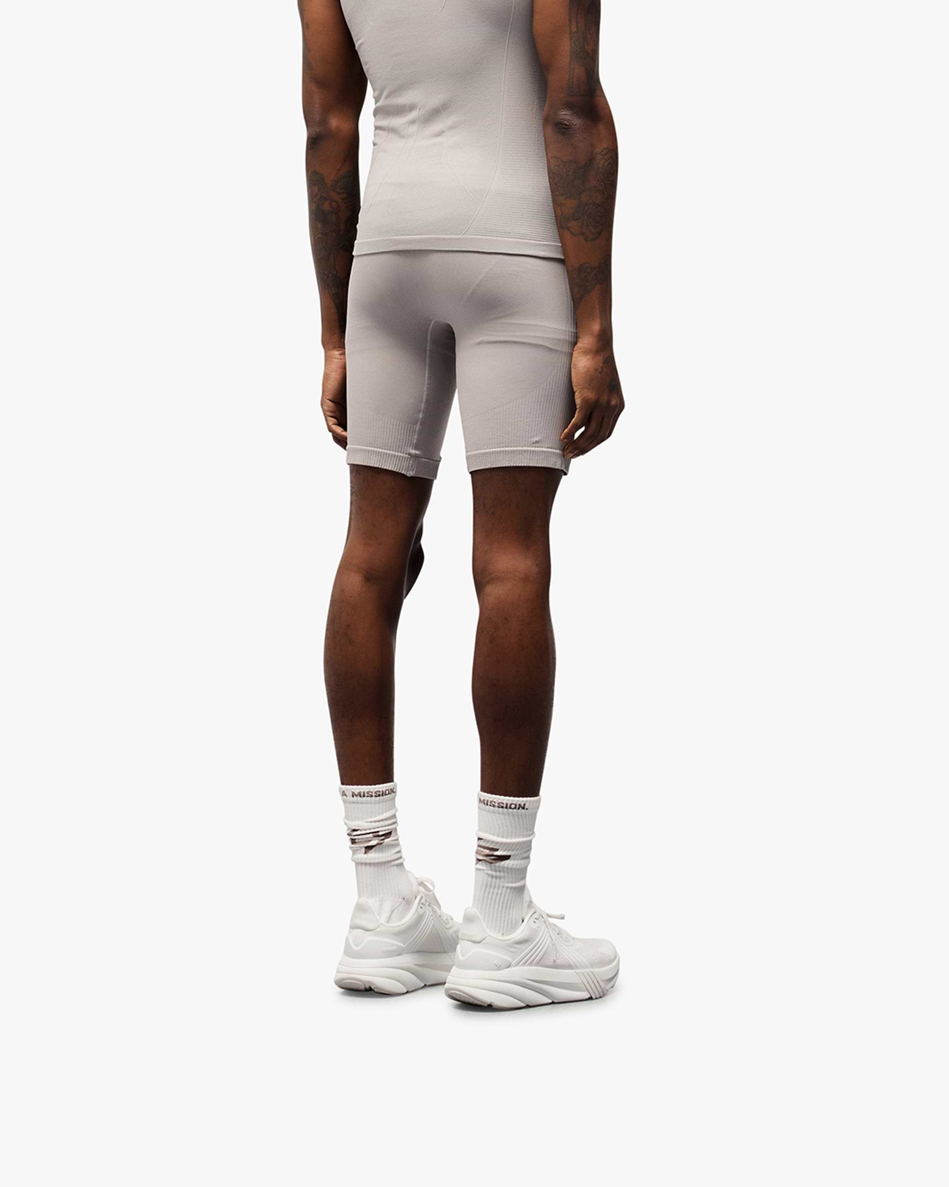 Man wearing grey seamless shorts on a plain white background | 247 DNA Seamless Shorts in Titanium | Seamless shorts with knit structured panels | 247 Shorts | Represent Clo