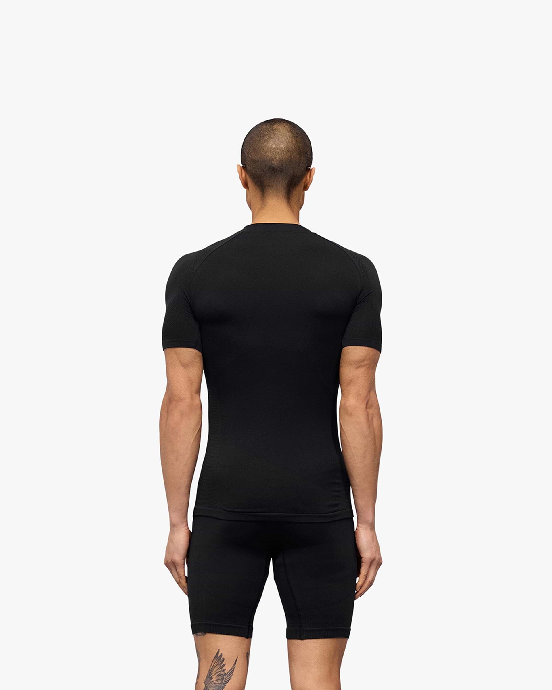 Man wearing a black seamless t-shirt on a plain white background | 247 DNA Seamless T-Shirt in Black | Seamless slim fit t-shirt for performance | 247 T-Shirts | Represent Clo