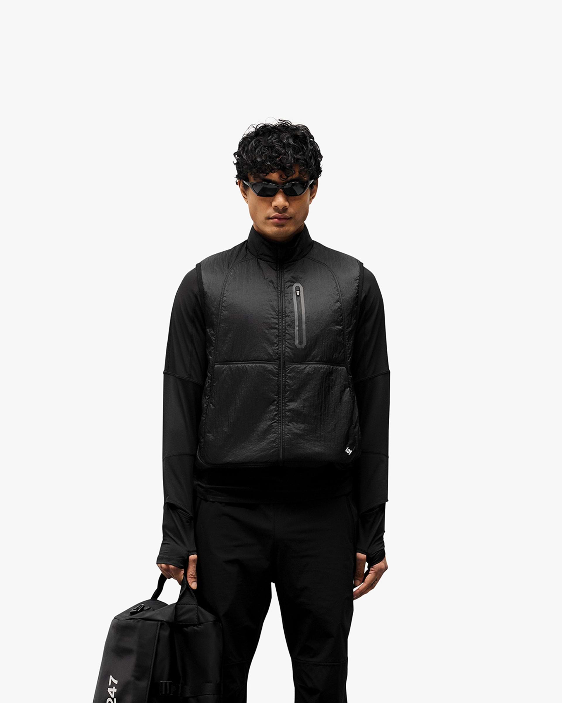 Man wearing a black running gilet on a plain white background | 247 Run Gilet in Black | Running gilet with insulation and zip pockets | 247 Outerwear | Represent Clo
