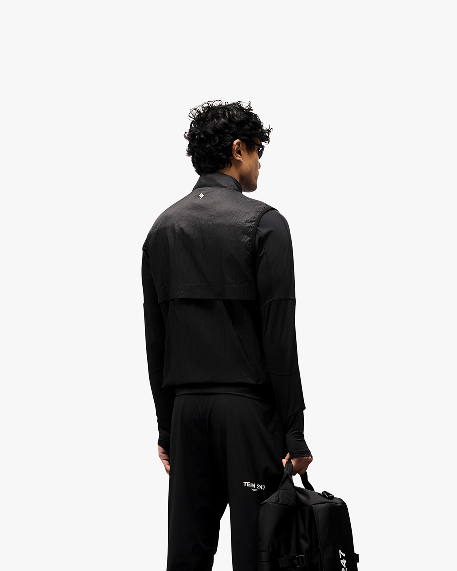 Man wearing a black gilet on a plain white background | 247 Run Gilet in Black | Gilet with insulation and windproof front | 247 Outerwear | Represent Clo