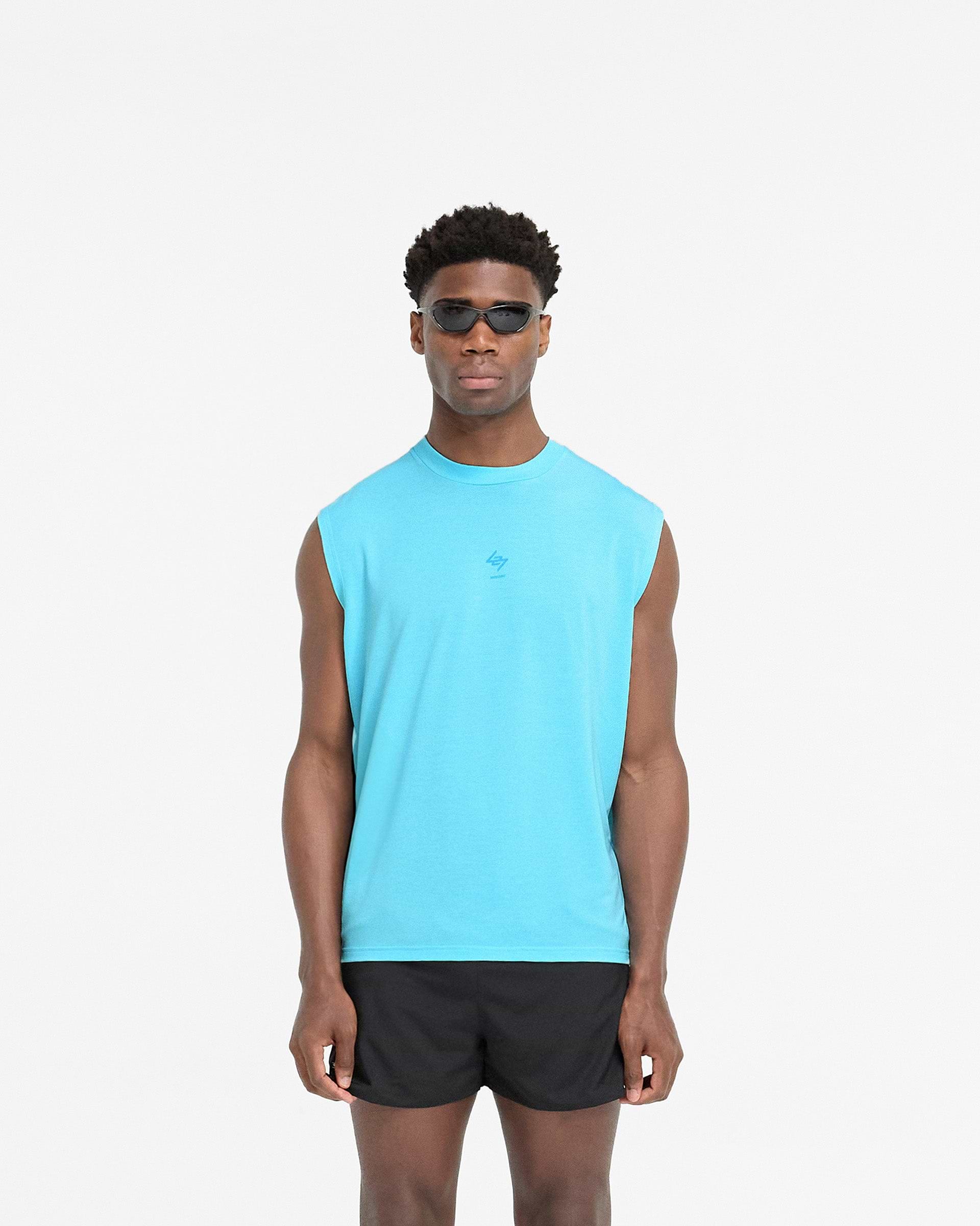 Man wearing an oversized blue tank on a plain white background | 247 Oversized Tank in Ultra Blue | Tank top with breathable fabric and 4-way stretch | 247 T-Shirts | Represent Clo