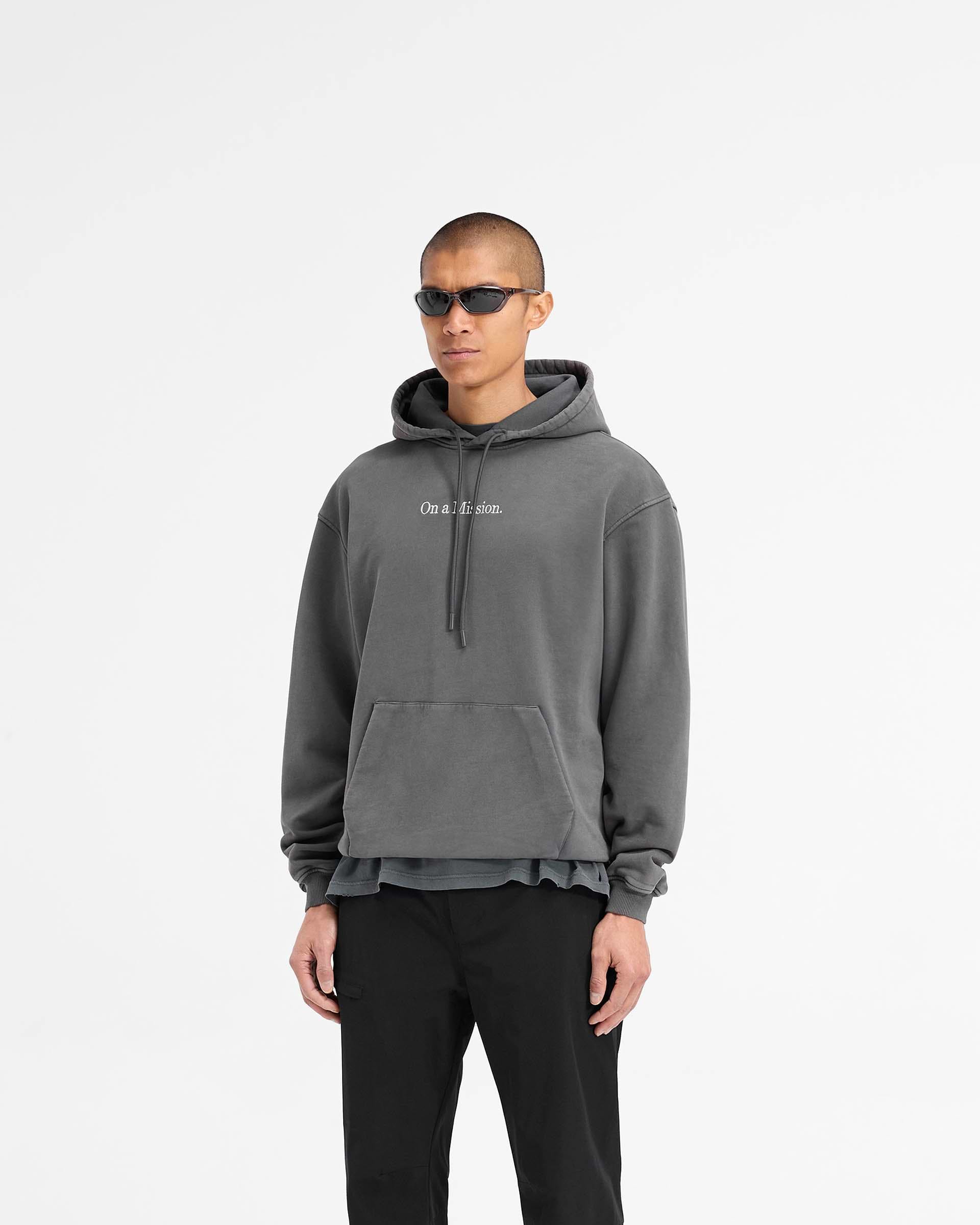 Back product image of a mens black hoodie on a plain white background | 247 On A Mission Hoodie in Aged Black | Slightly oversized hoodie with On a Mission embroidery and ribbed trims | 247 Hoodies | Represent Clo
