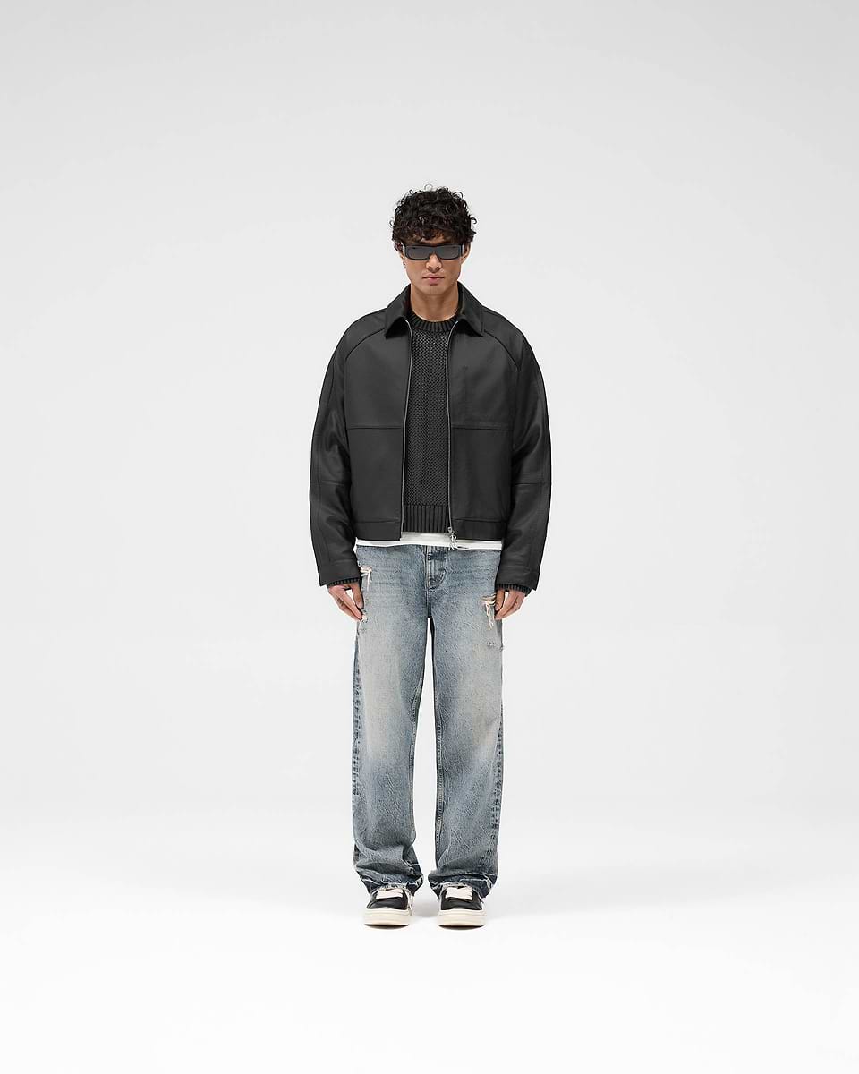 Man wearing a black leather jacket on a plain white background | Overdrive Leather Jacket in Black | Oversized leather jacket with structured sleeves | SS25 Outerwear | Represent Clo