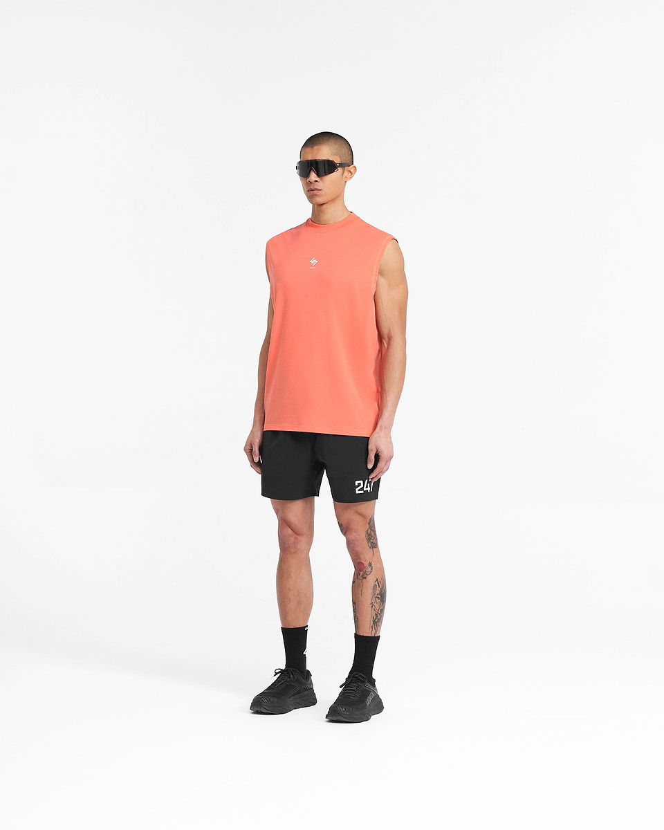 Man wearing a coral tank top on a plain white background | 247 Oversized Tank in Coral | Oversized tank with quick drying fabric | 247 T-Shirts | Represent Clo