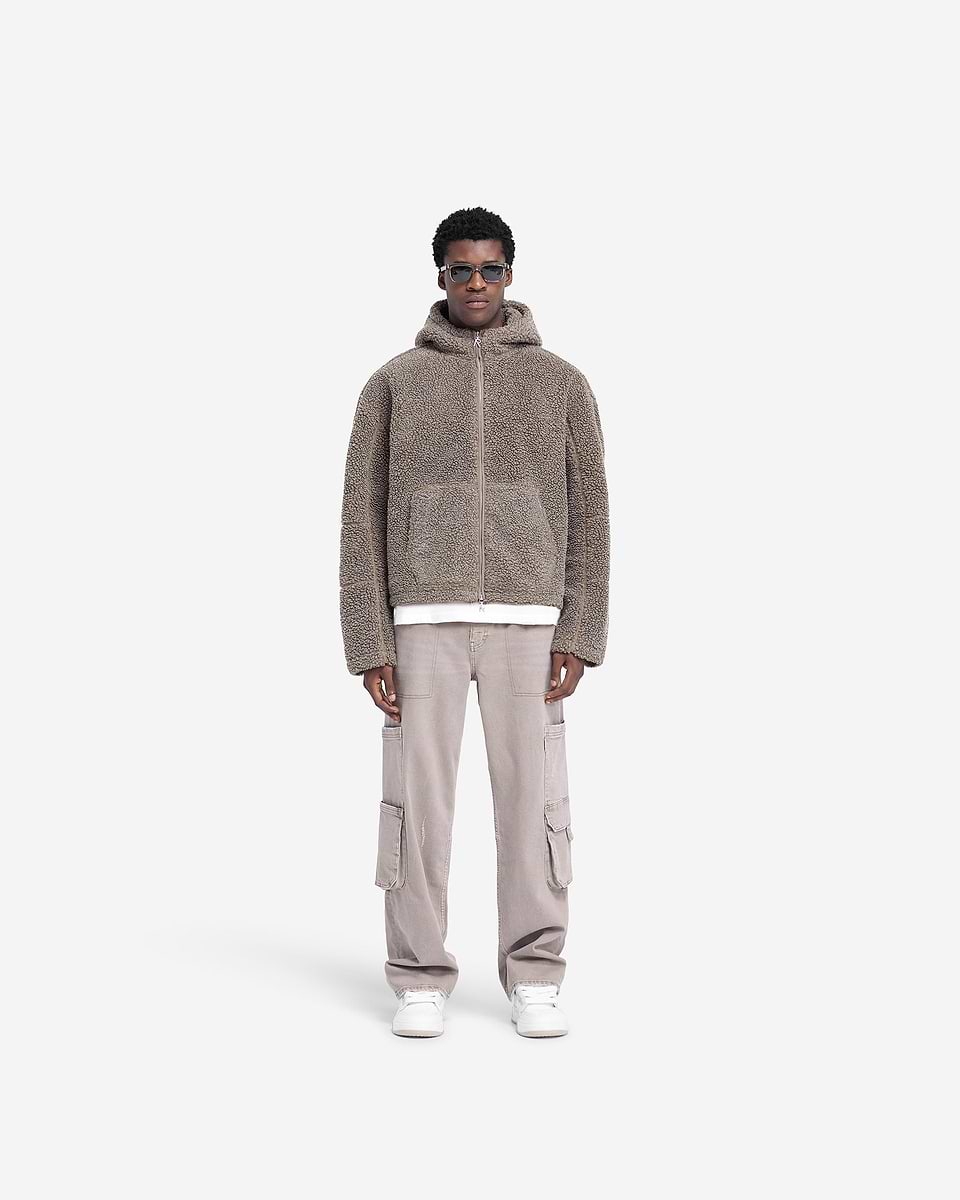 Man wearing a grey oversized hooded jacket on a plain white background | Hooded Fleece Jacket in Rock | Boxy fit with a kangaroo pocket and adjustable hem | FW24 Outerwear | Represent Clo