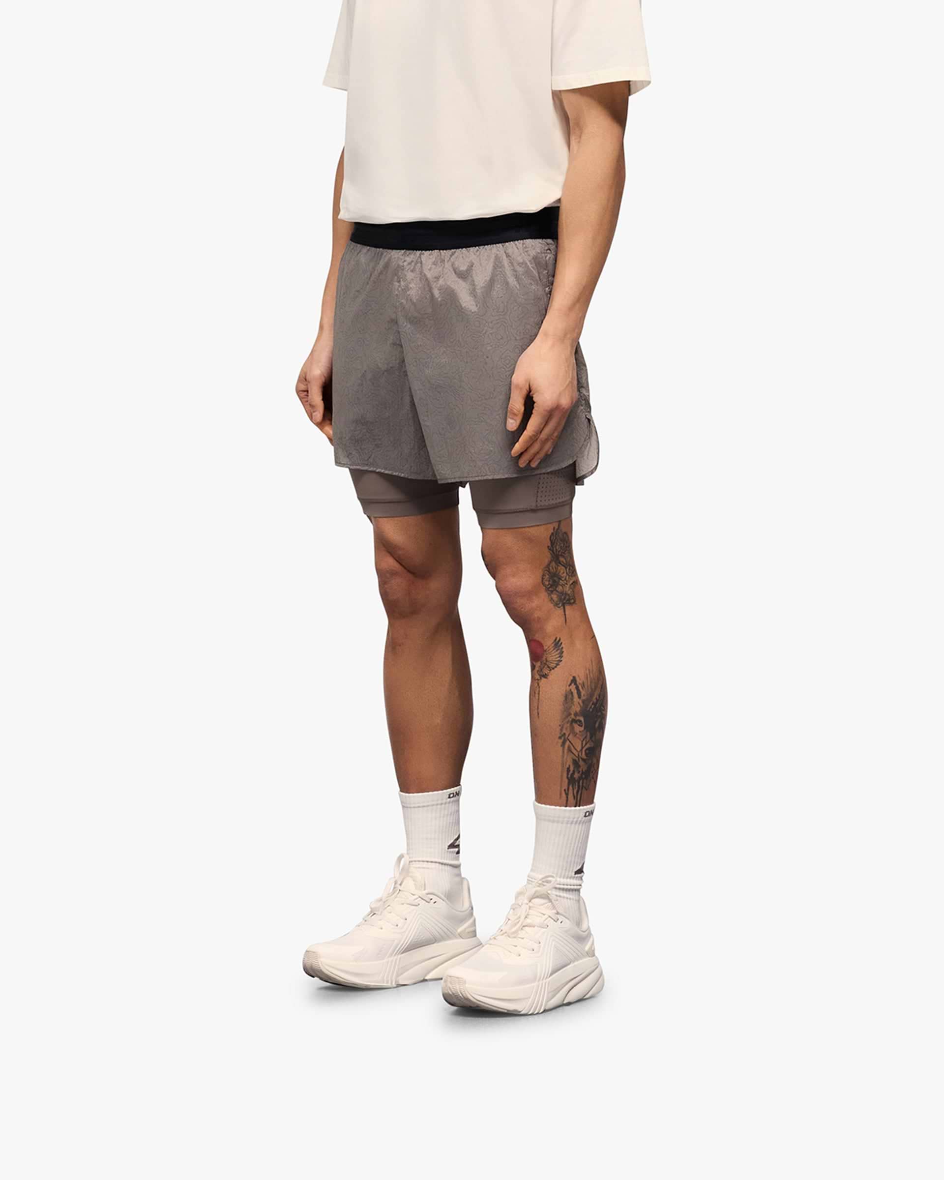 Back product image of mens grey shorts on a plain white background | 247 Contour 2-In-1 Run Shorts in Pebble | Shorts with inner legging and zip pockets | 247 Shorts | Represent Clo