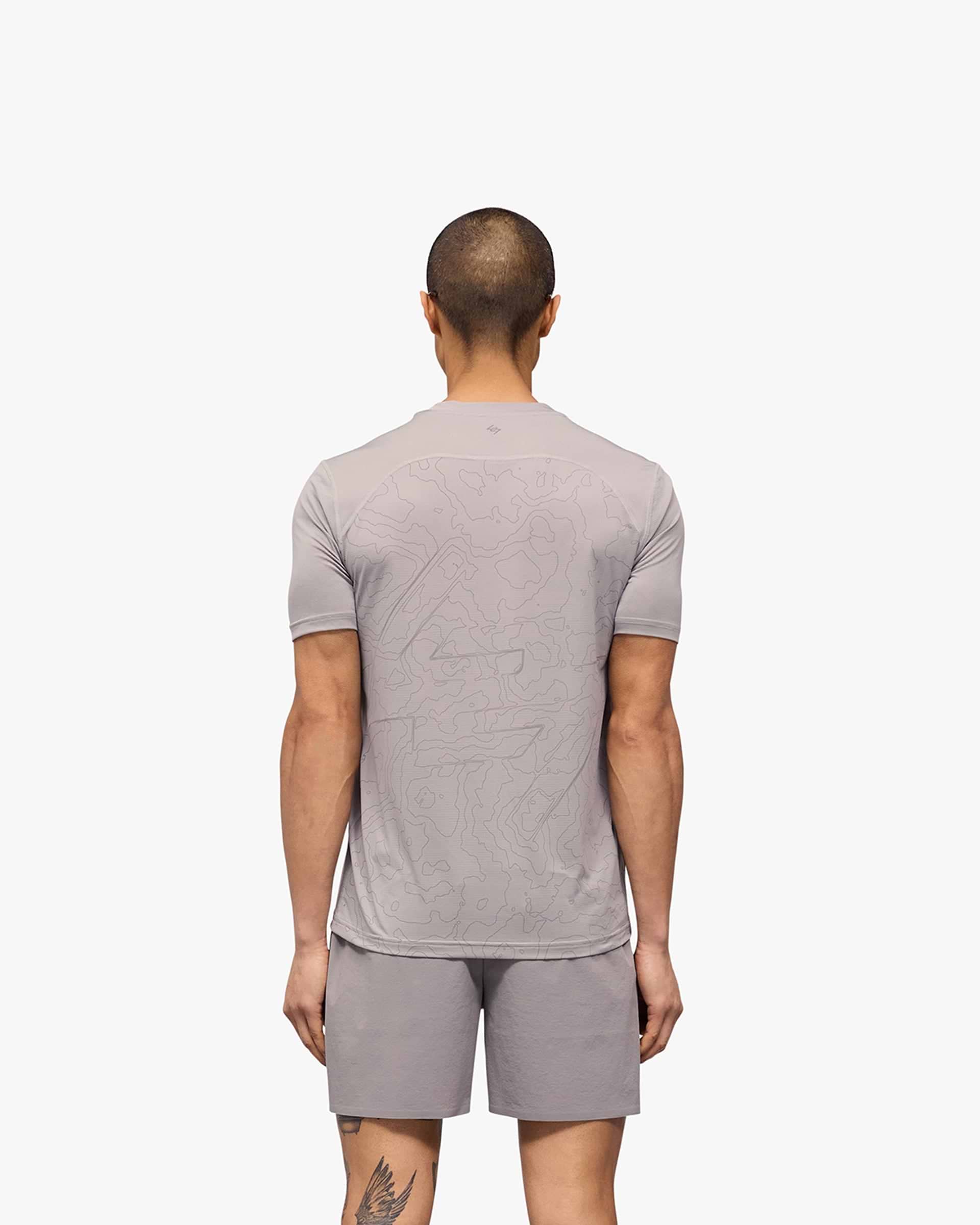 Man wearing a grey running t-shirt on a plain white background | 247 Contour Run T-Shirt in Titanium | Breathable mesh running t-shirt | 247 T-Shirts | Represent Clo