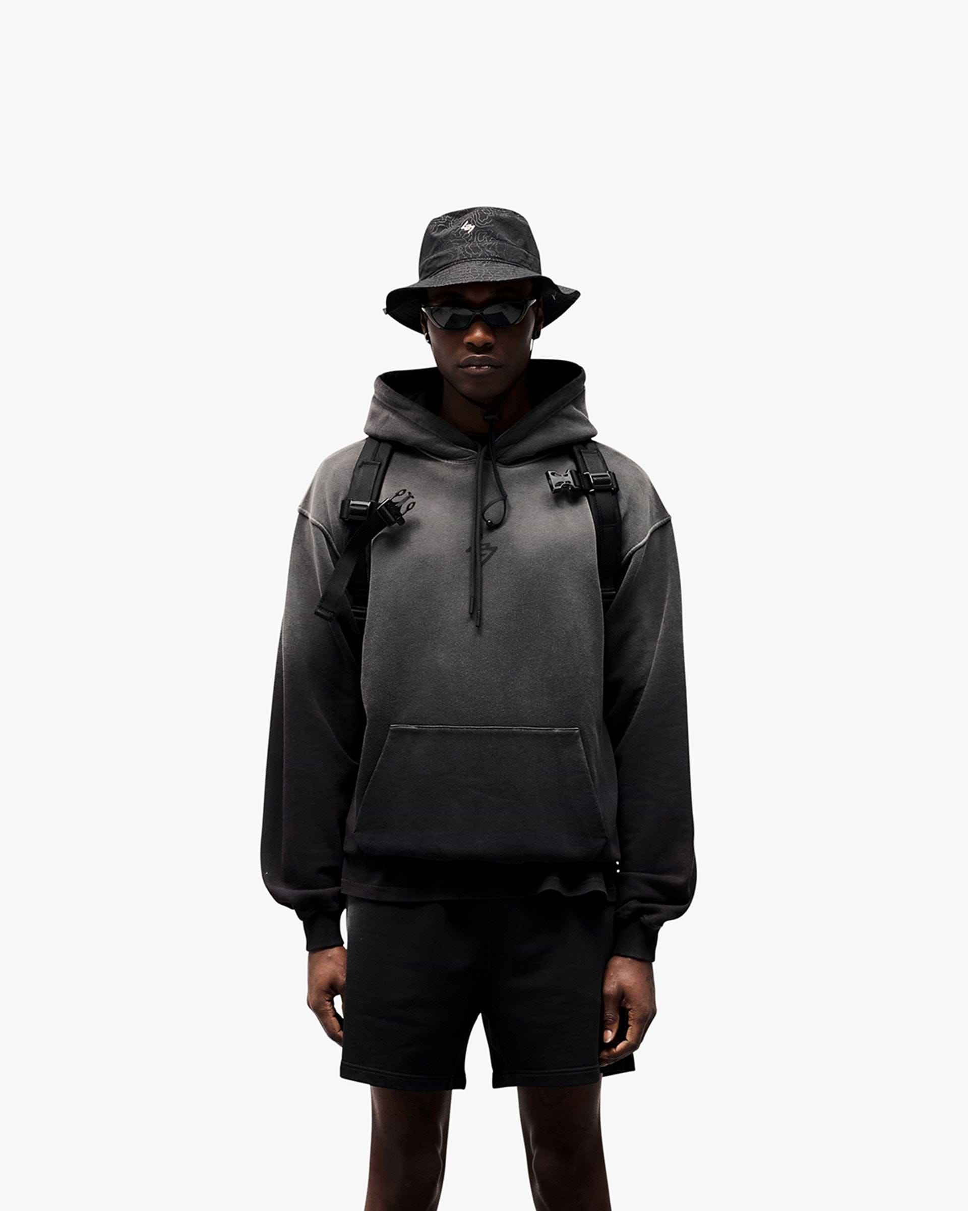 Man wearing an oversized black hoodie on a plain white background | 247 Motion Oversized Hoodie in Black | Oversized hoodie with ribbed hem and cuffs | 247 Hoodies | Represent Clo