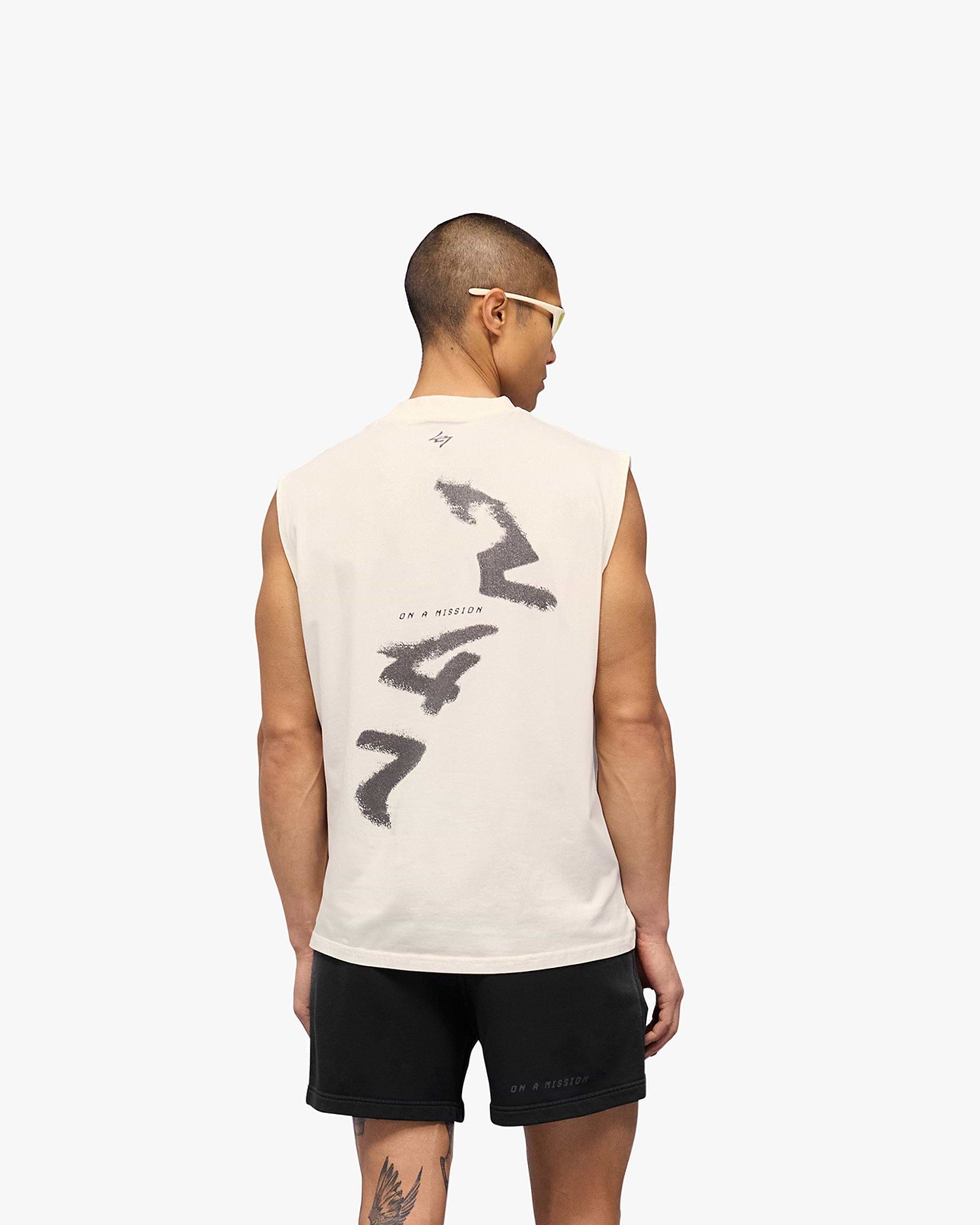 Man wearing a white oversized tank on a plain white background | 247 Motion Oversized Tank in Flat White | Tank with graphic print and sweat-wicking fabric | 247 T-Shirts | Represent Clo