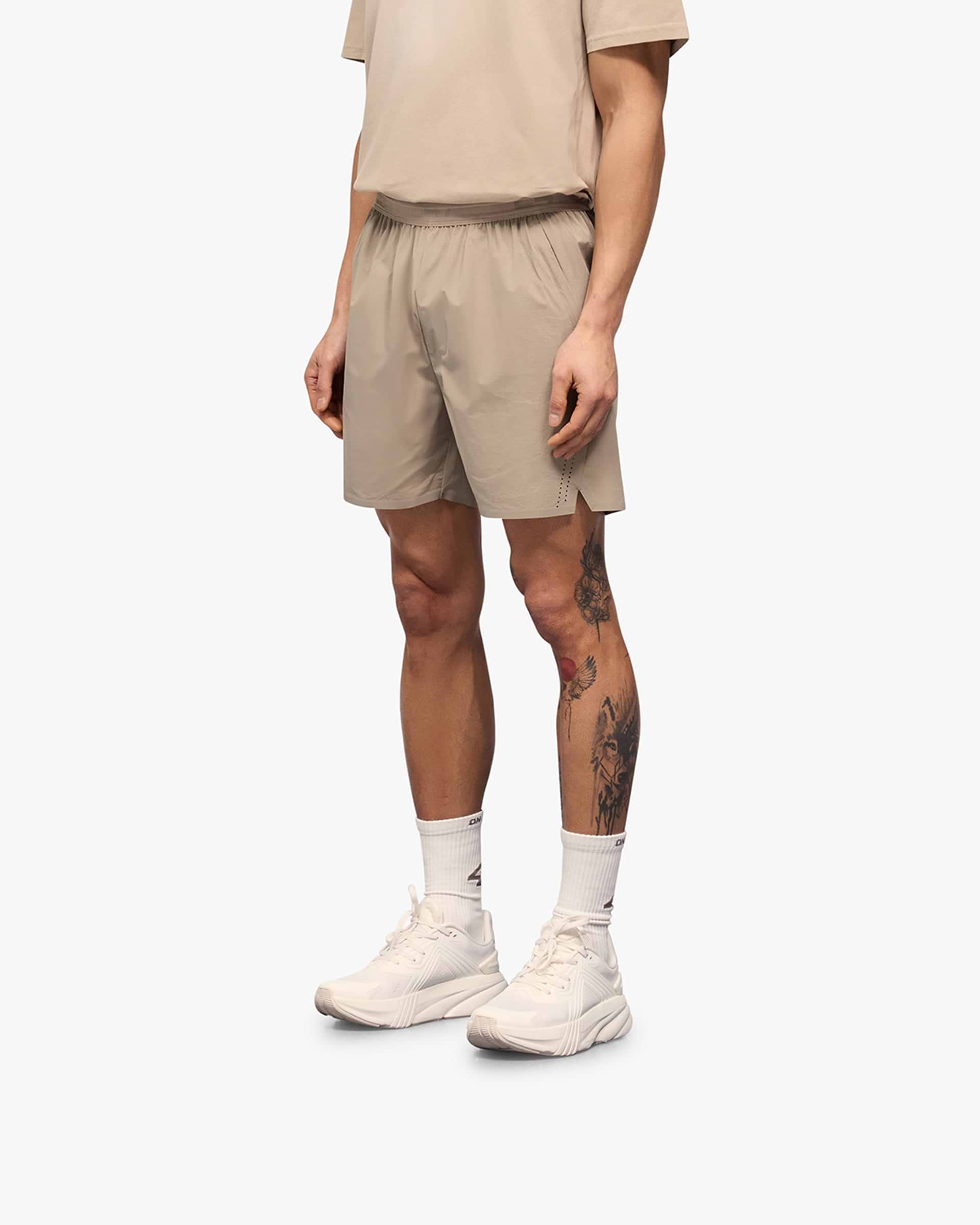 Back product image of mens grey shorts on a plain white background | 247 Training Shorts in Pebble | Shorts with perforation detailing and zip pockets | 247 Shorts | Represent Clo