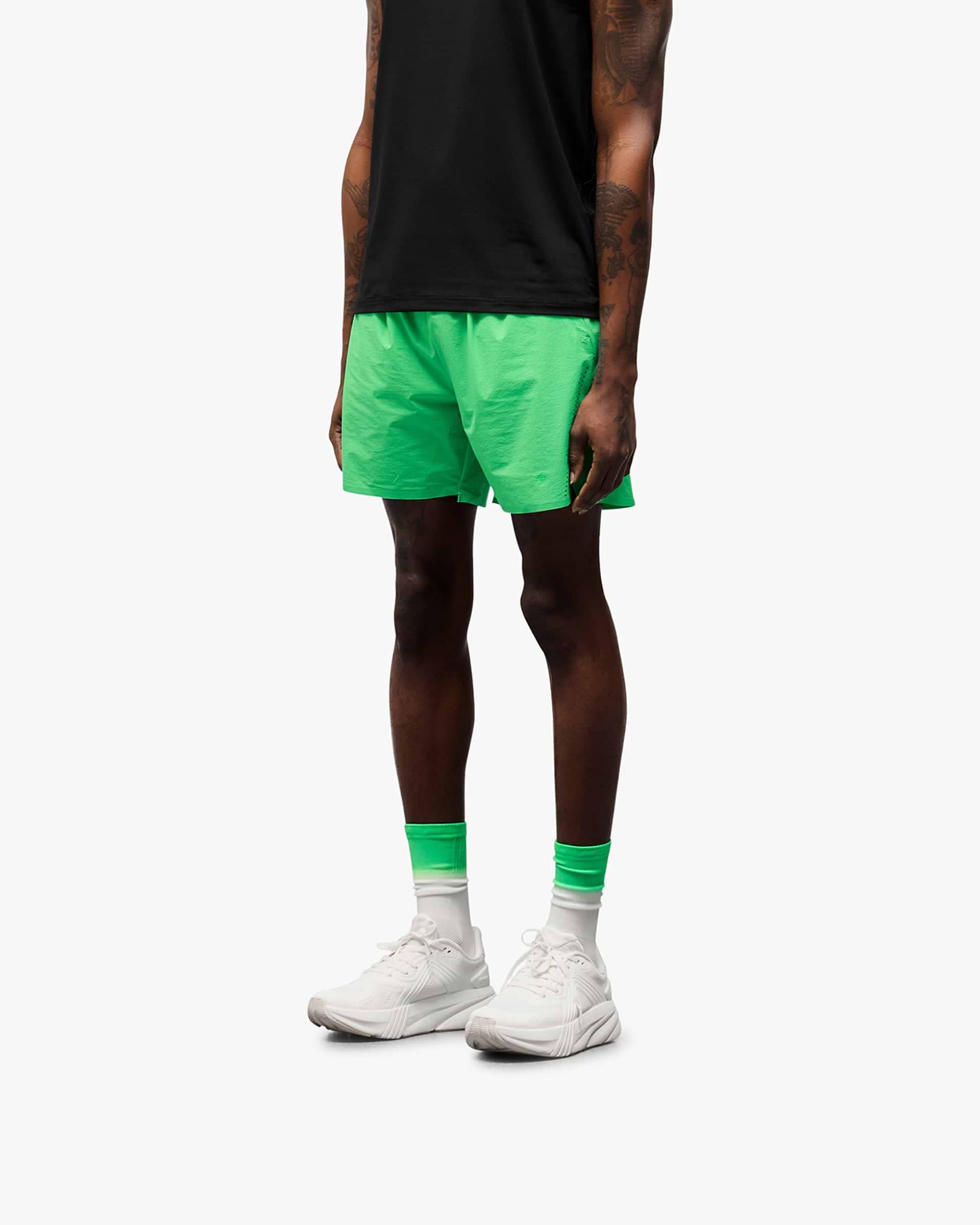 Back product image of mens green shorts on a plain white background | 247 Training Shorts in Speed Green | Nylon shorts with perforation detailing and zip pockets | 247 Shorts | Represent Clo