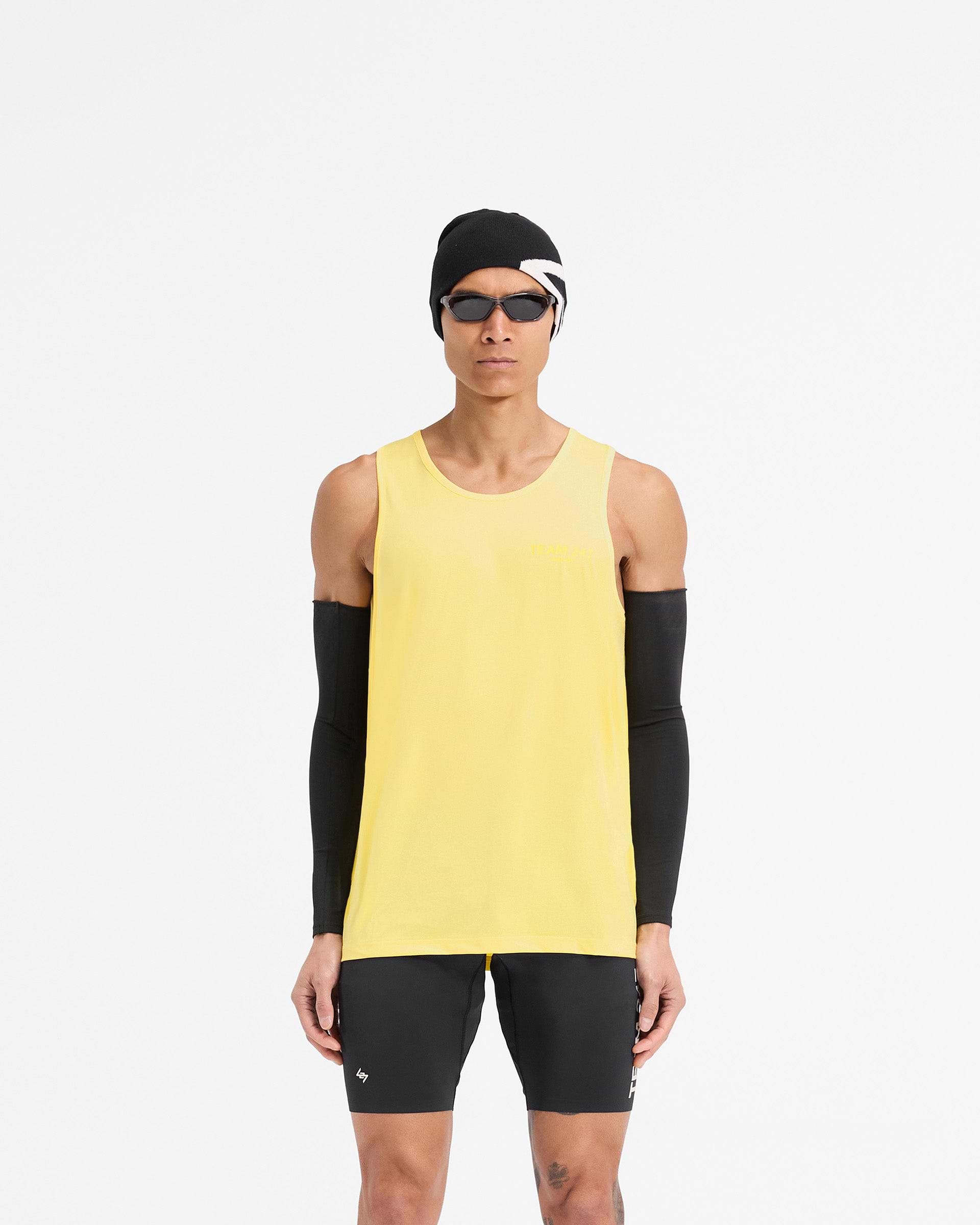 Man wearing a yellow running vest on a plain white background | Team 247 Run Vest in Lemon | Lightweight breathable running vest with moisture wicking | 247 T-Shirts | Represent Clo