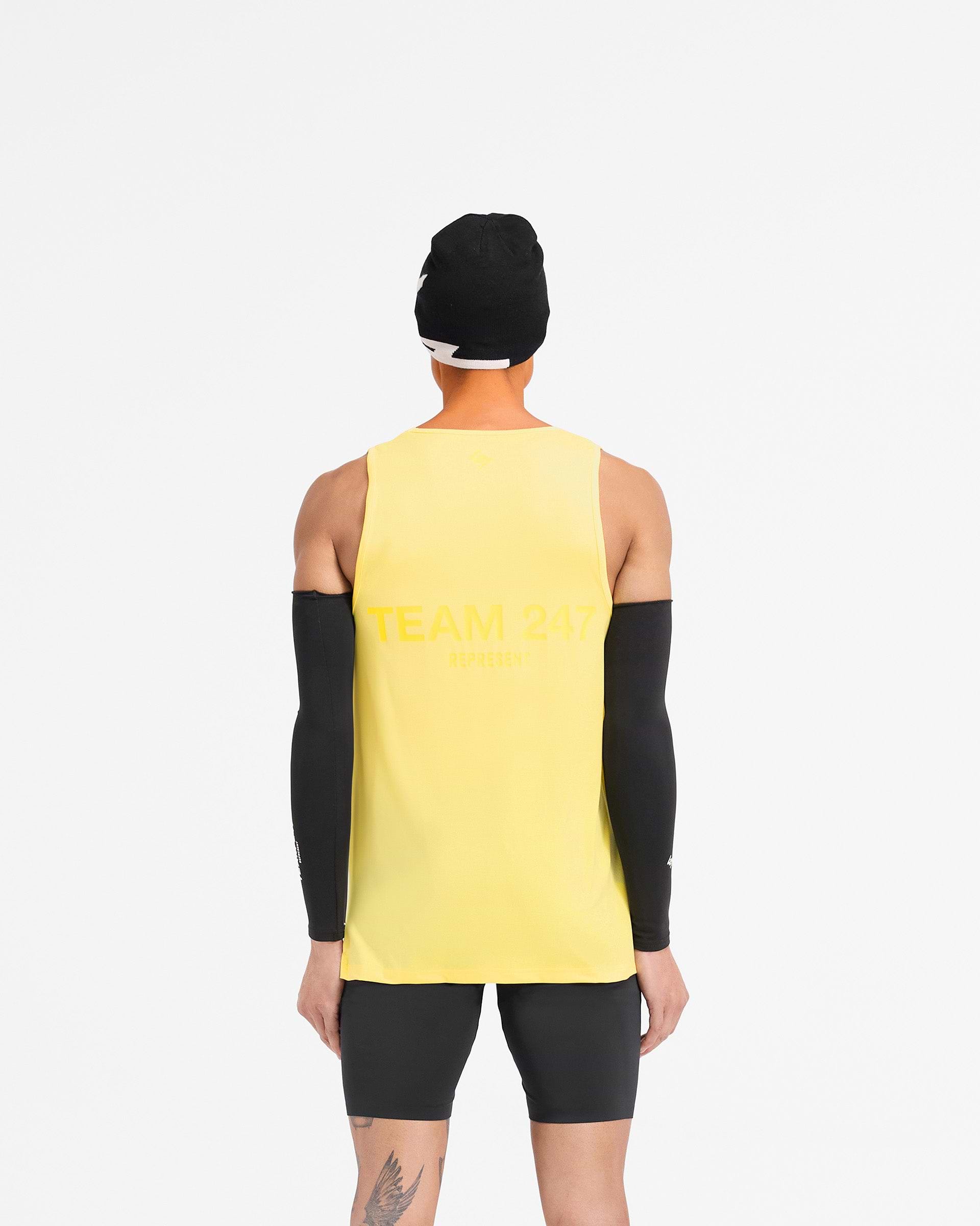 Man wearing a yellow running vest on a plain white background | Team 247 Run Vest in Lemon | Lightweight breathable vest with Team 247 branding | 247 T-Shirts | Represent Clo