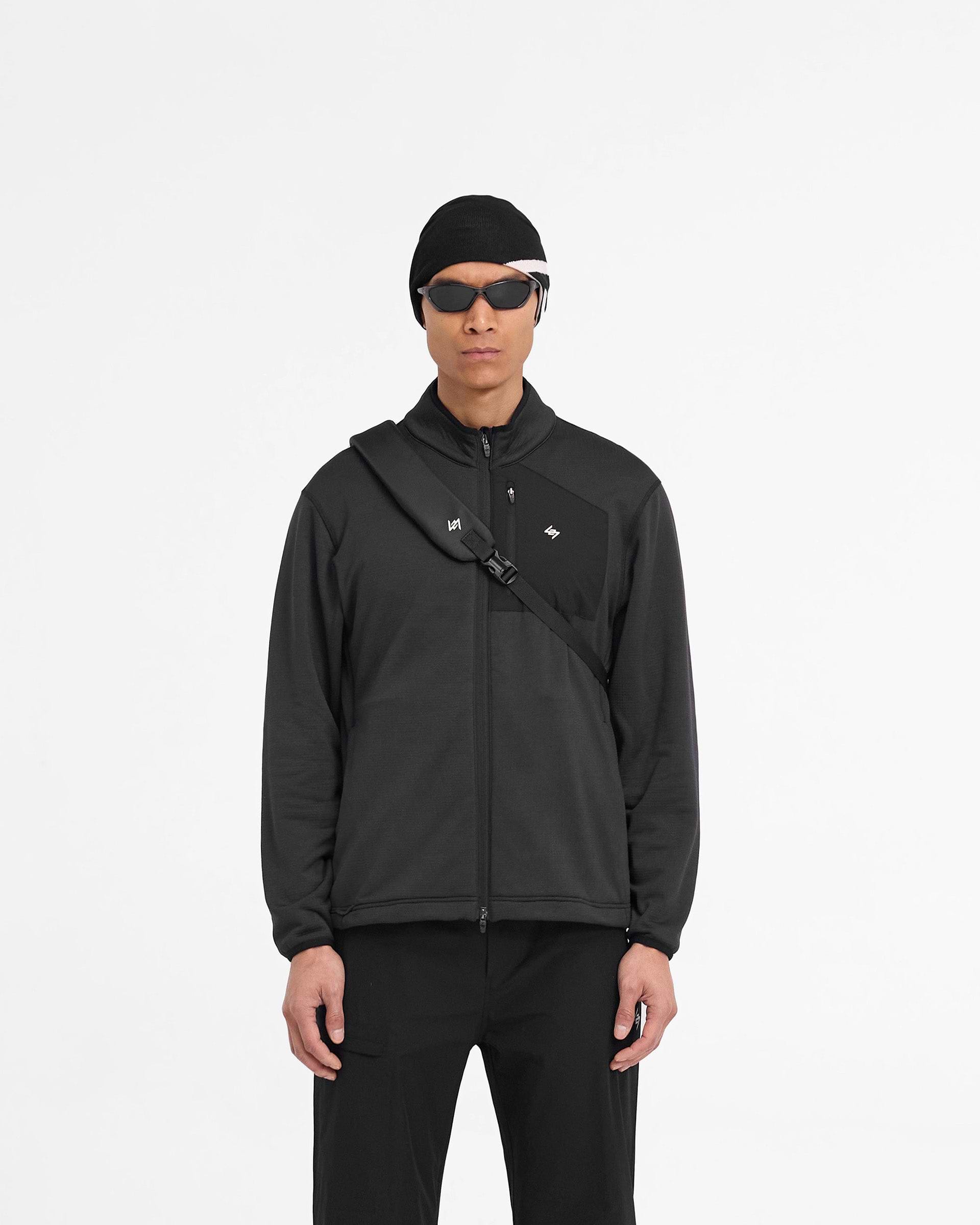 Man wearing a black fleece jacket on a plain white background | 247 Full Zip Fleece in Black | Regular fit fleece jacket with zip pockets | 247 Outerwear | Represent Clo