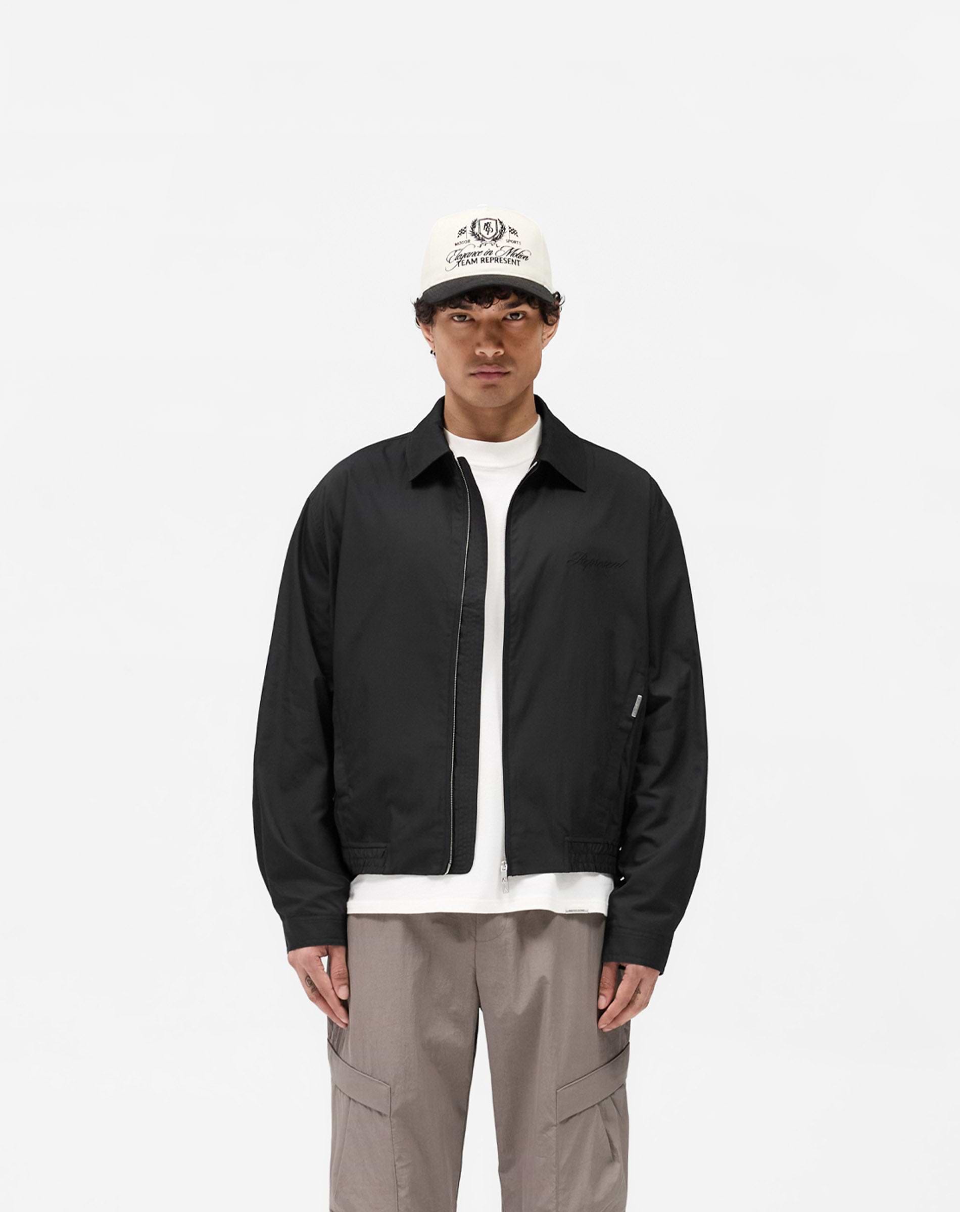 Man wearing a black bomber jacket shirt on a plain white background | Shirt Bomber in Black | Lightweight overshirt with welt pockets | SS25 Shirts | Represent Clo