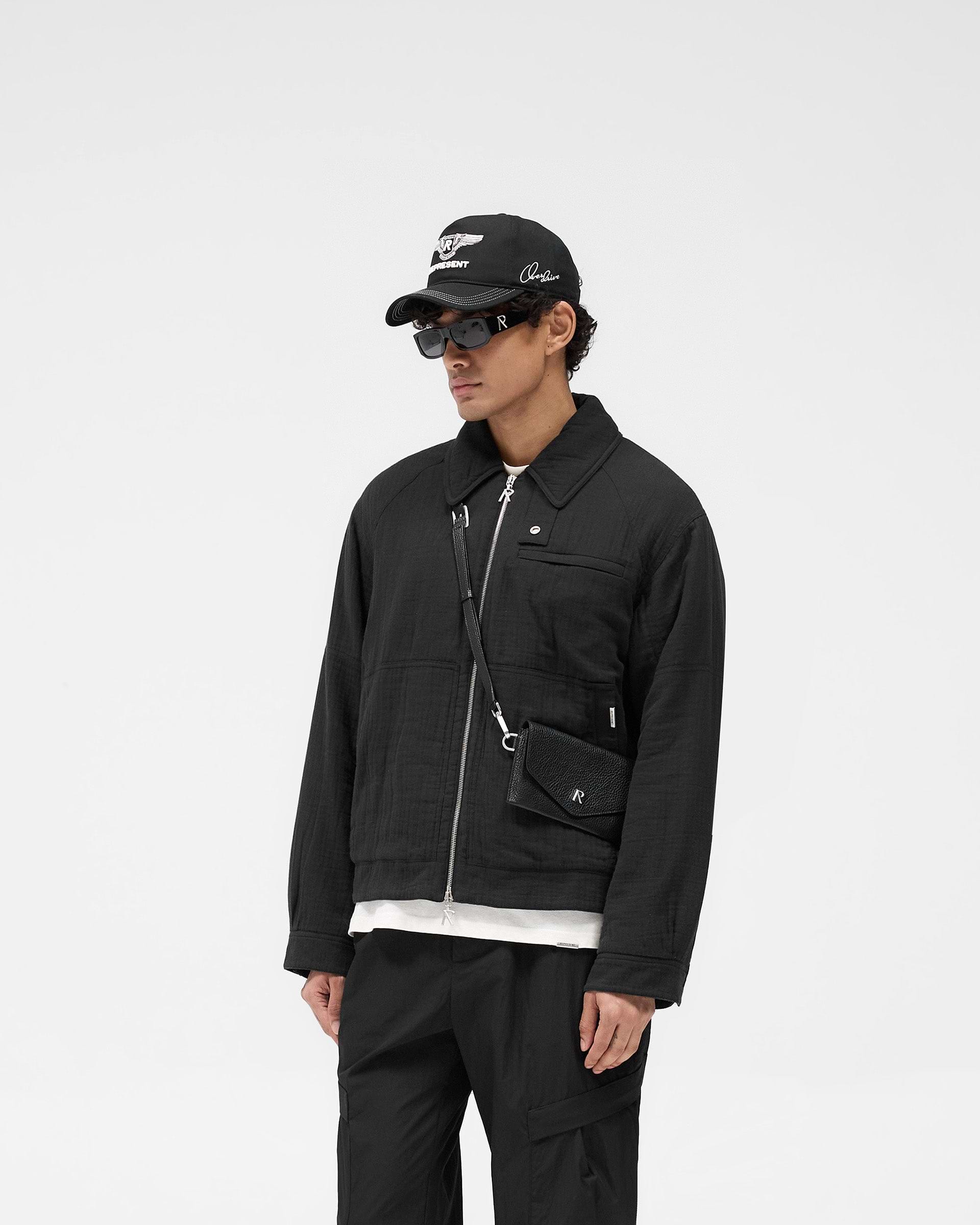 Back product image of a mens black jacket on a plain white background | Crinkle Trucker Jacket in Black | Jacket with oversized shirt collar and adjustable popper cuffs | SS25 Outerwear | Represent Clo