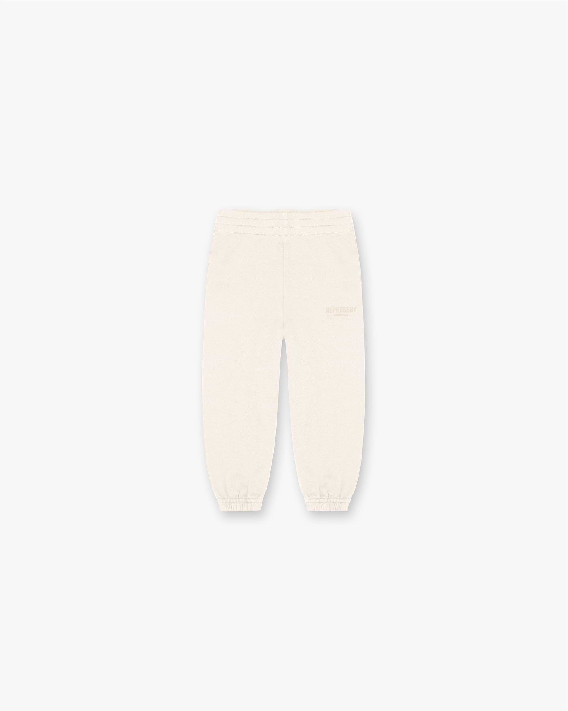 Front product image of a child's cream sweatpants on a plain white background | Mini Owners Club Sweatpants in Buttercream | Soft pants with elastic waistband | SS23 Pants | Represent Clo