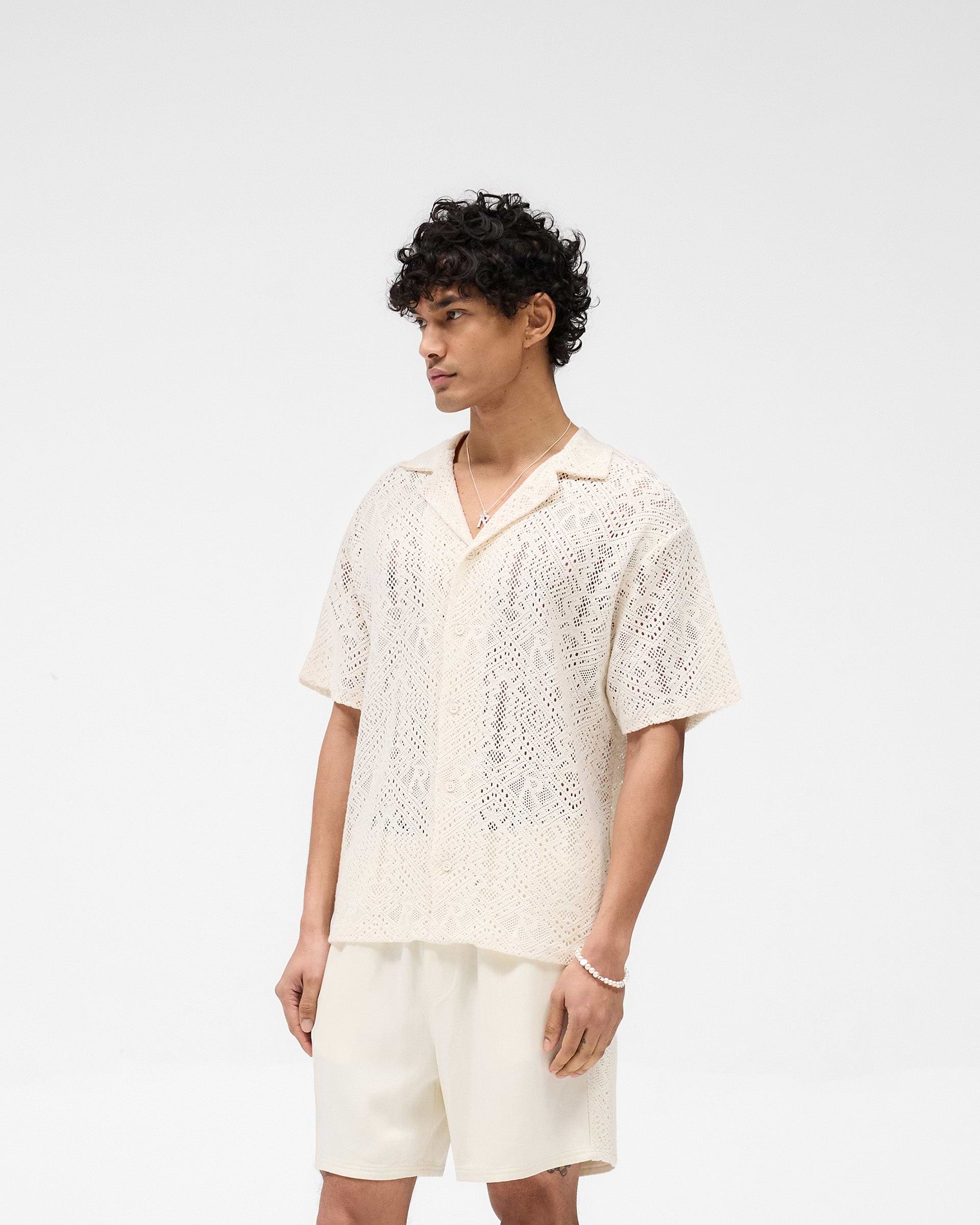 Back product image of a mens white crochet shirt on a plain white background | All Over Crochet Shirt in Off White | Lightweight open-knit crochet shirt with monogram pattern | SS25 Knitwear | Represent Clo