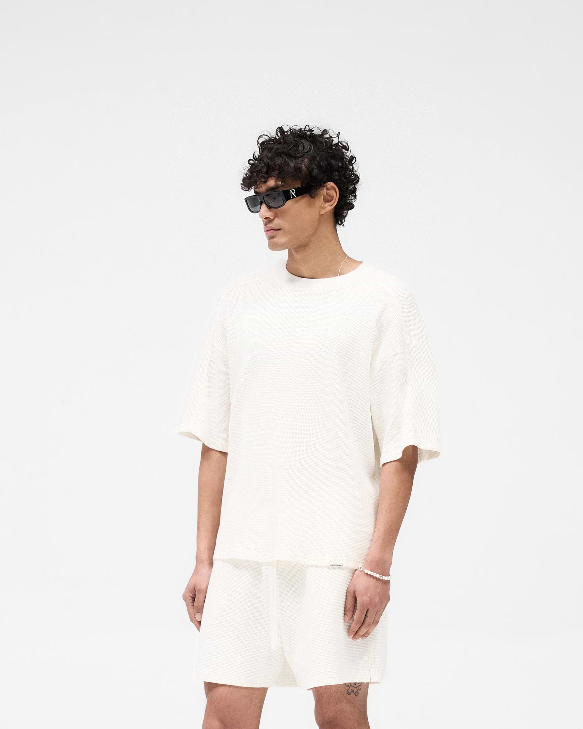 Back product image of a mens white t-shirt on a plain white background | Waffle T-Shirt in Flat White | Boxy fit t-shirt with interlock waffle texture | SS25 T-Shirts | Represent Clo