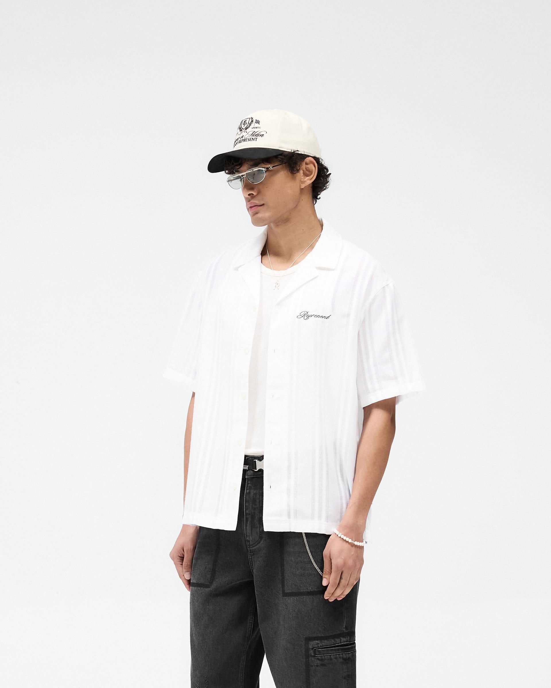 Back product image of a mens white shirt on a plain white background | Embroidered Bowling Shirt in Antique White | Sheer bowling shirt with button-down front | SS25 Shirts | Represent Clo