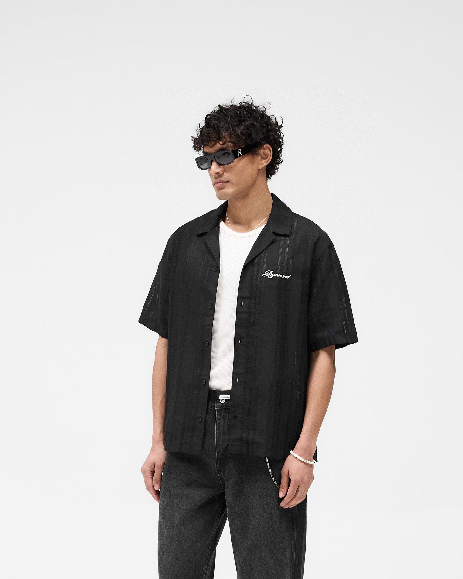 Back product image of a mens black bowling shirt on a plain white background | Embroidered Bowling Shirt in Jet Black | Sheer bowling shirt with embroidered logo | SS25 Shirts | Represent Clo