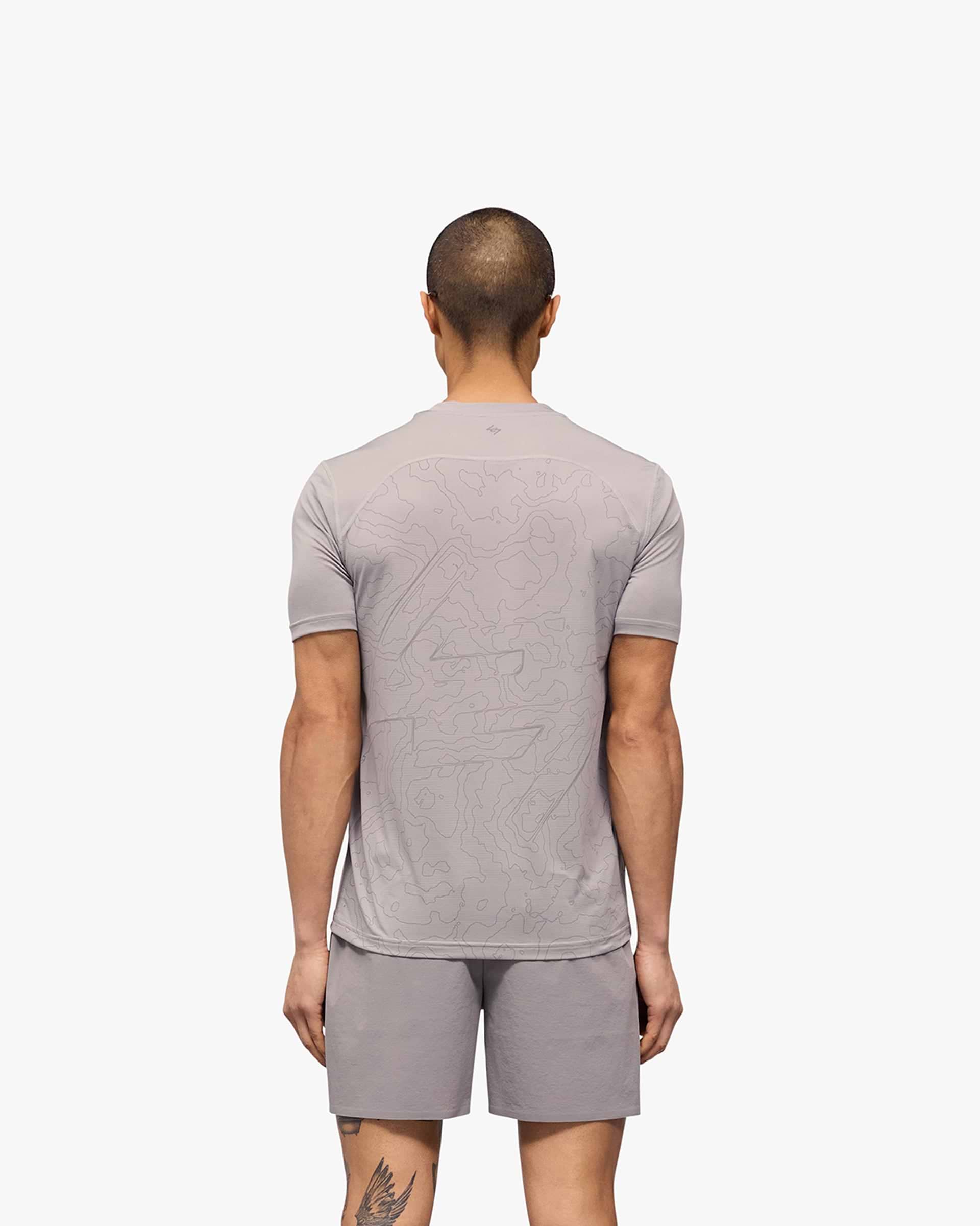 Man wearing a grey running t-shirt on a plain white background | 247 Contour Run T-Shirt in Titanium | Breathable mesh running t-shirt | 247 T-Shirts | Represent Clo