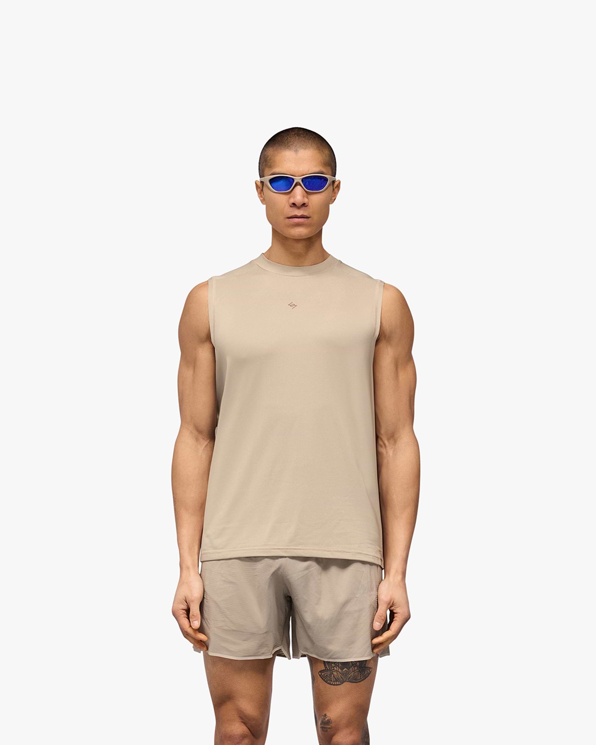Man wearing a grey running tank on a plain white background | 247 Contour Run Tank in Pebble | Breathable sweat-wicking technical tank | 247 T-Shirts | Represent Clo
