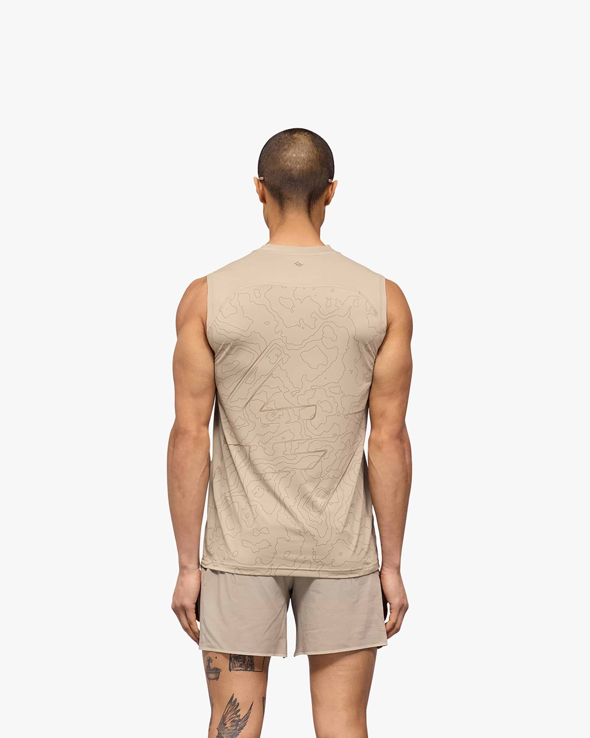 Man wearing a grey running tank on a plain white background | 247 Contour Run Tank in Pebble | Breathable mesh running tank | 247 T-Shirts | Represent Clo