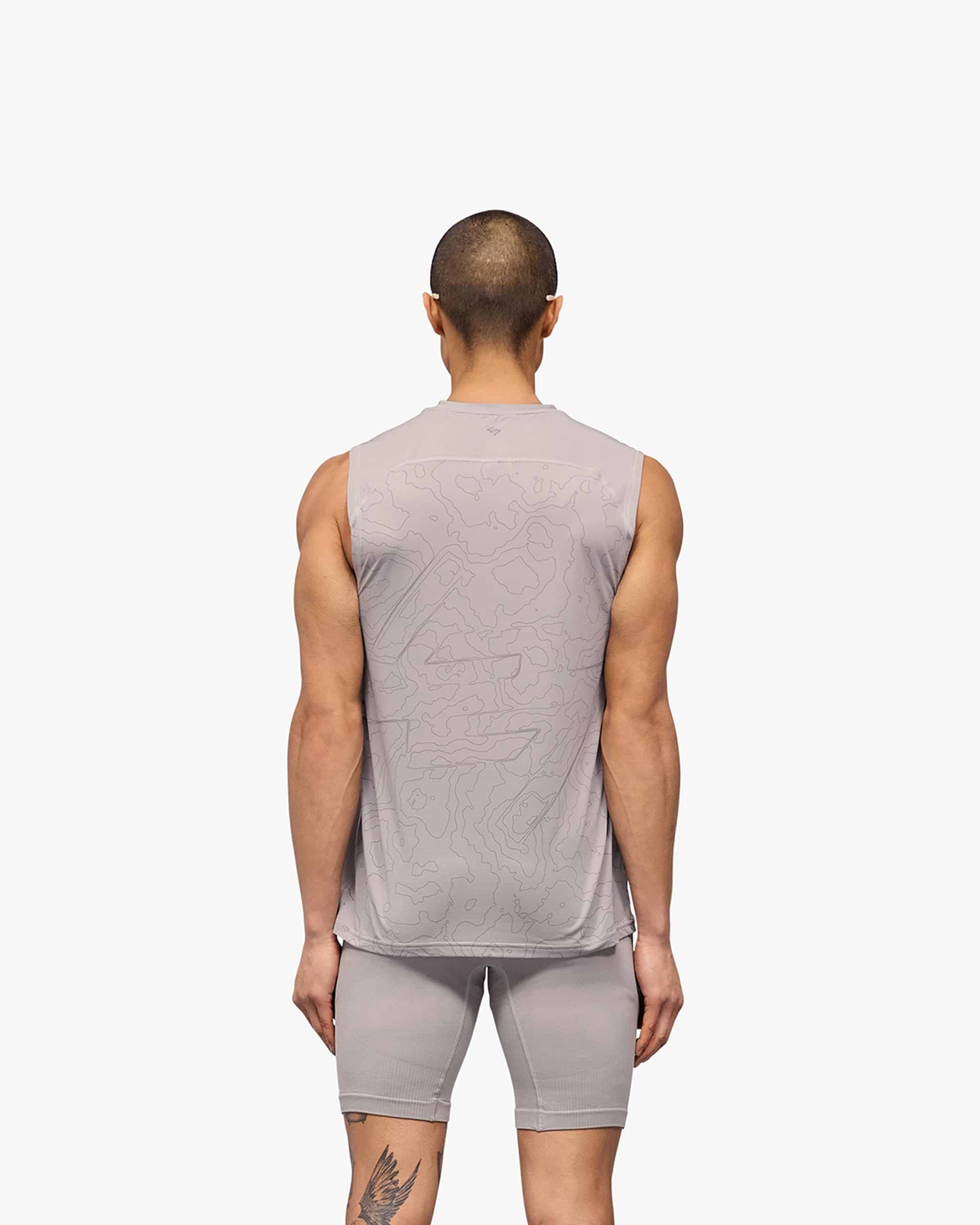 Man wearing a grey running tank on a plain white background | 247 Contour Run Tank in Titanium | Breathable sweat-wicking running tank | 247 T-Shirts | Represent Clo